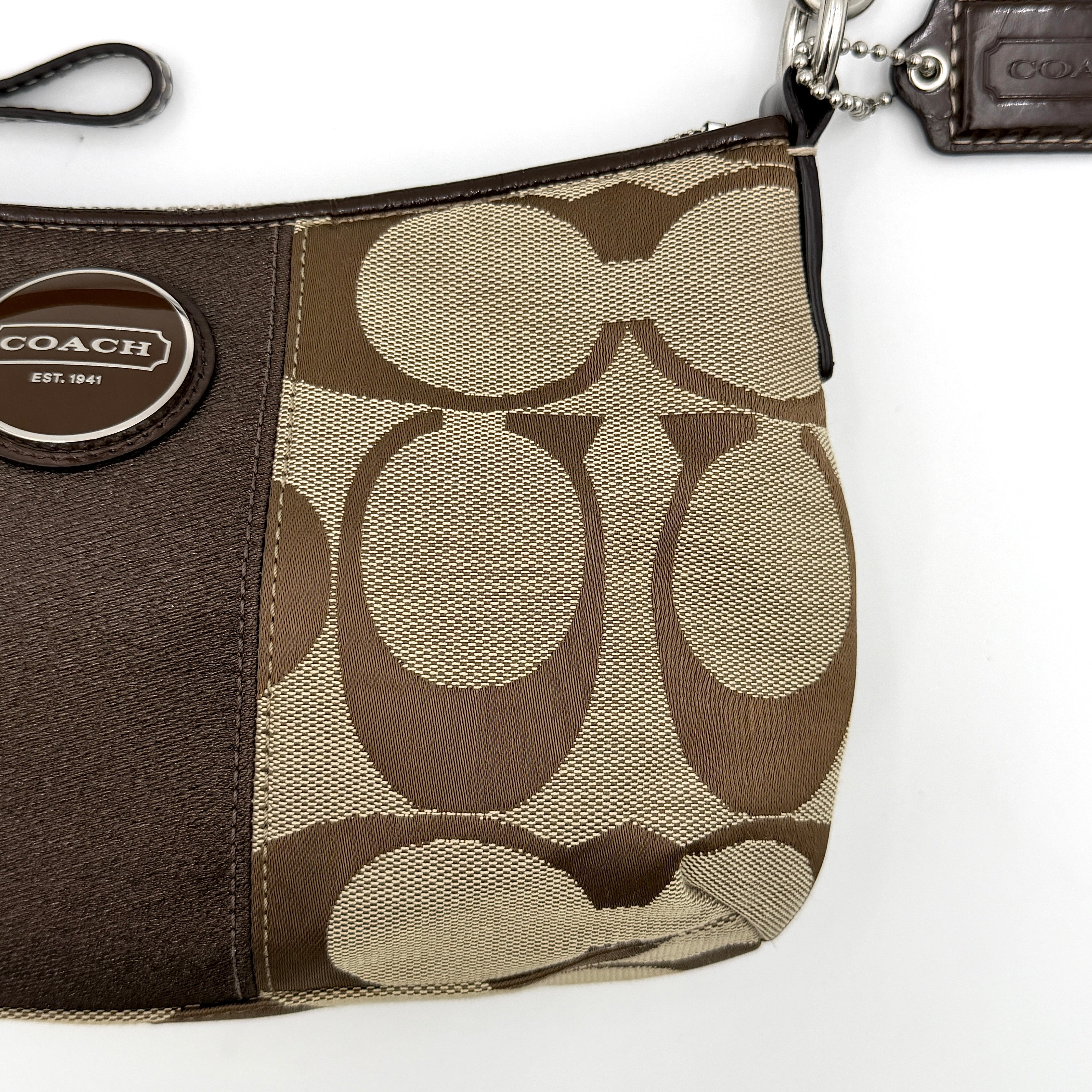 Coach khaki and mahogany signature jacquard shoulder bag with detachable strap and silver hardware displayed on a white background.