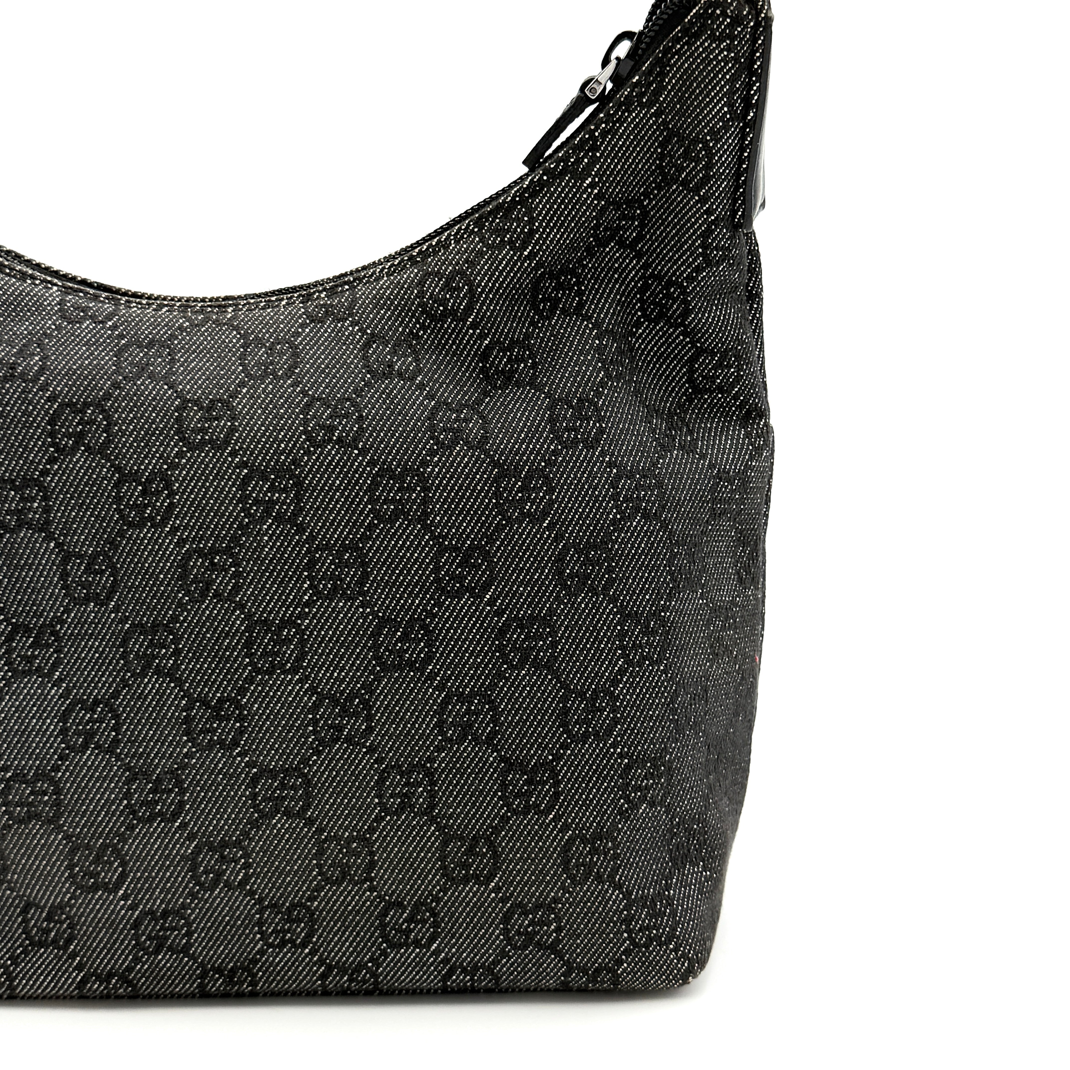 Gucci GG Monogram Hobo Shoulder Bag in black canvas with tonal GG pattern and a curved shoulder strap, photographed on a white background.