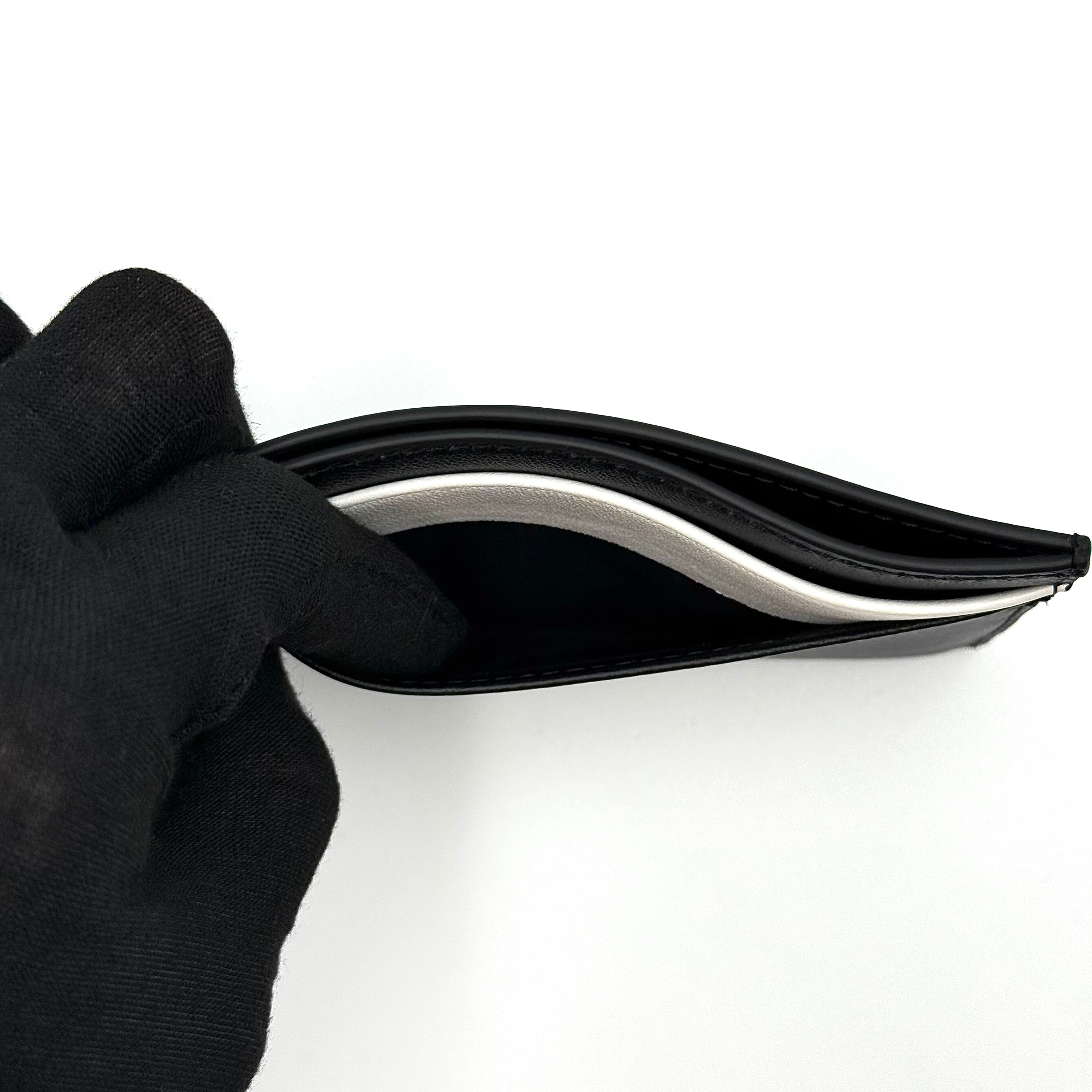 Furla WP00173 black leather cardholder with bold white logo and accent, shown against a white backdrop.