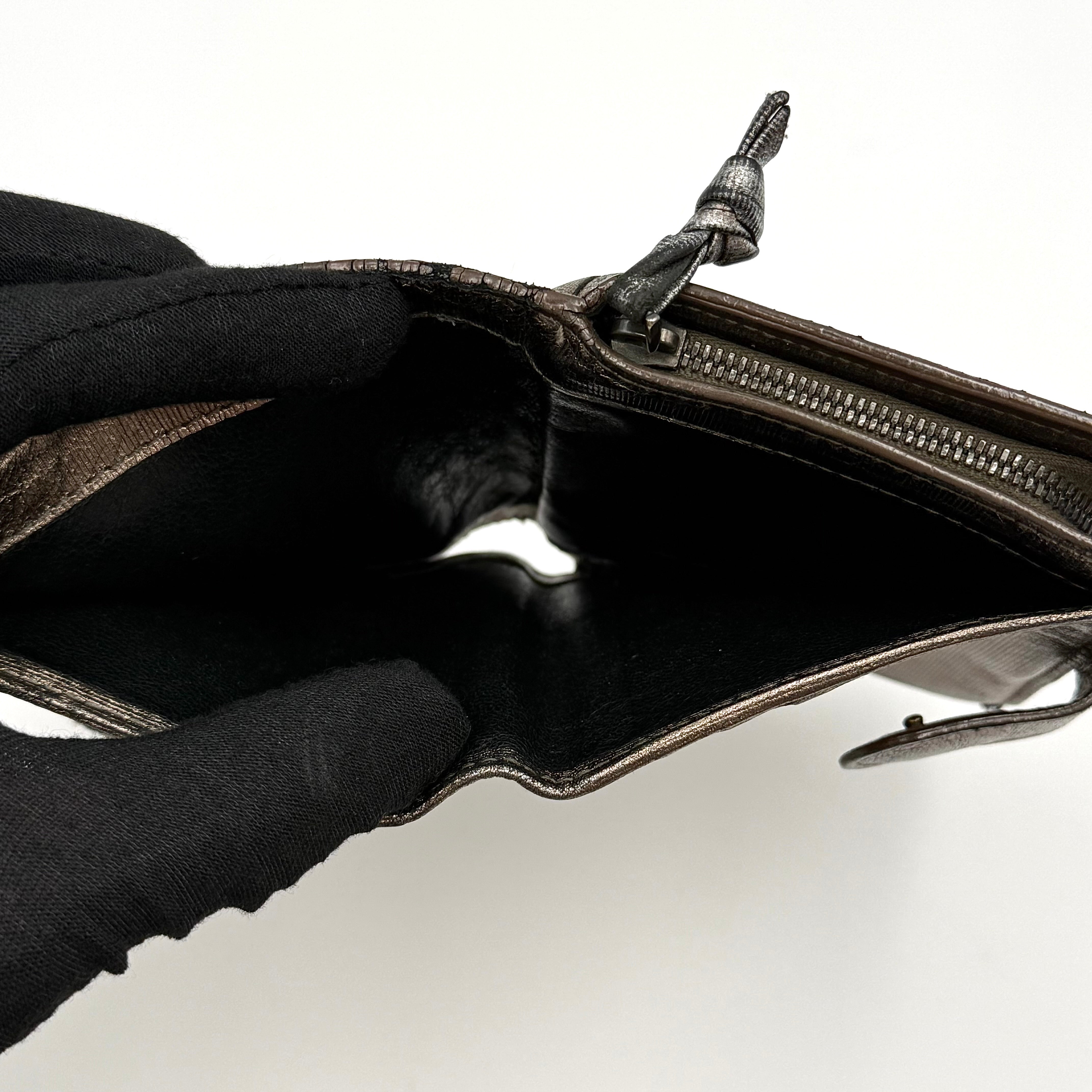 Bottega Veneta intrecciato metallic bronze leather wallet with snap tab and zip compartment.