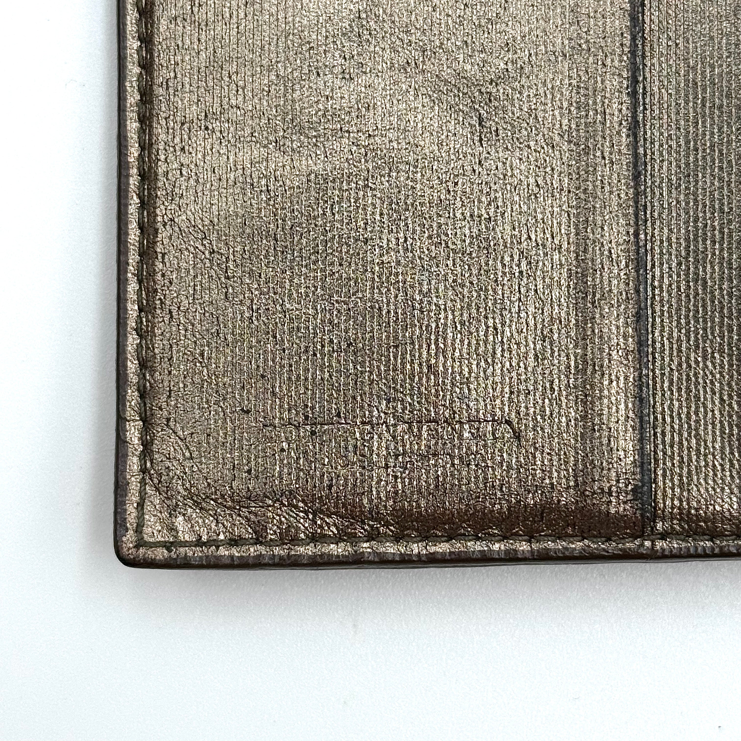 Bottega Veneta intrecciato metallic bronze leather wallet with snap tab and zip compartment.