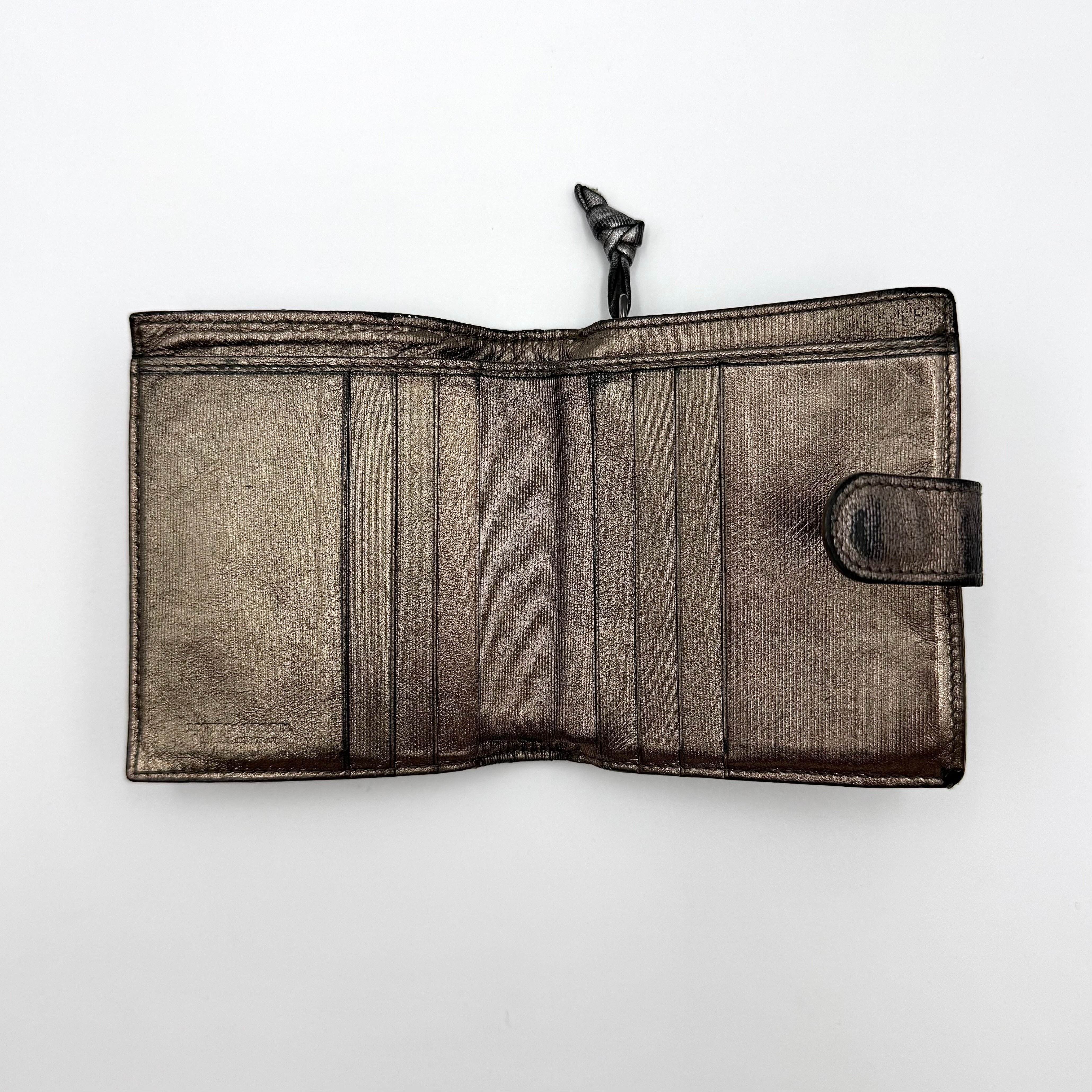 Bottega Veneta intrecciato metallic bronze leather wallet with snap tab and zip compartment.