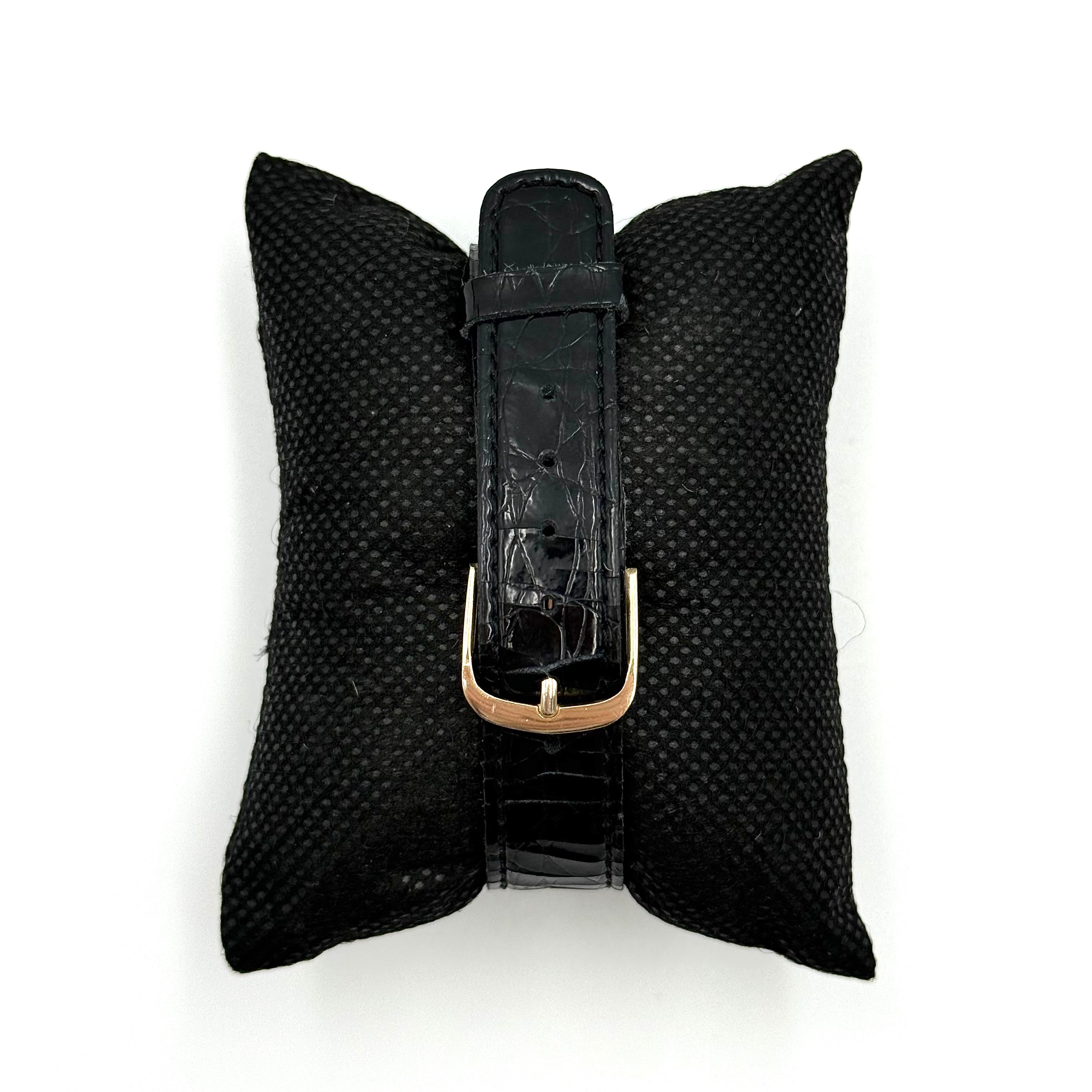 Seiko Avenue 7N01-6D50 gold watch with black textured leather strap displayed on a black cushion.