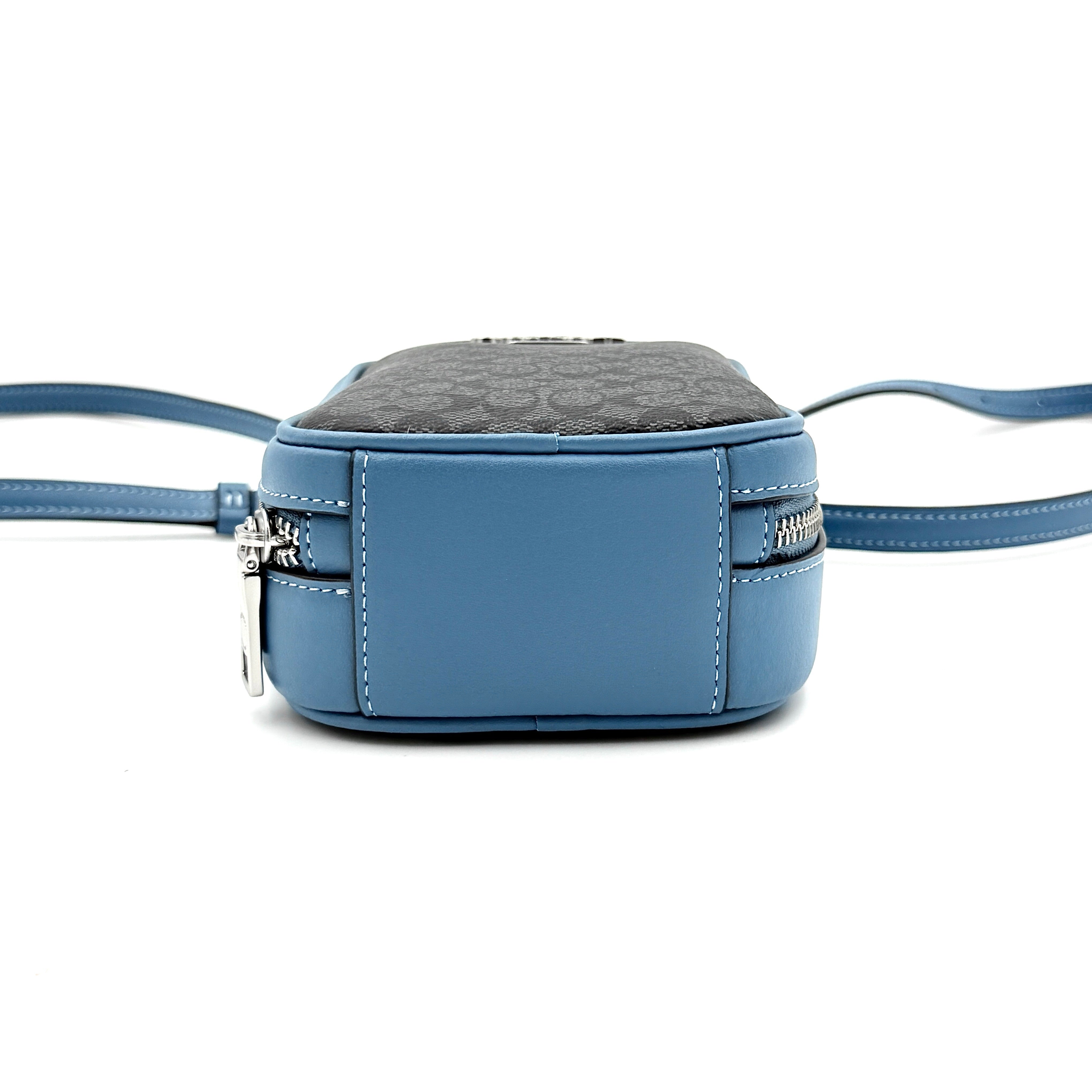 Coach Signature Eva Phone Crossbody in black coated canvas with blue leather trim and silver hardware displayed with its crossbody strap.
