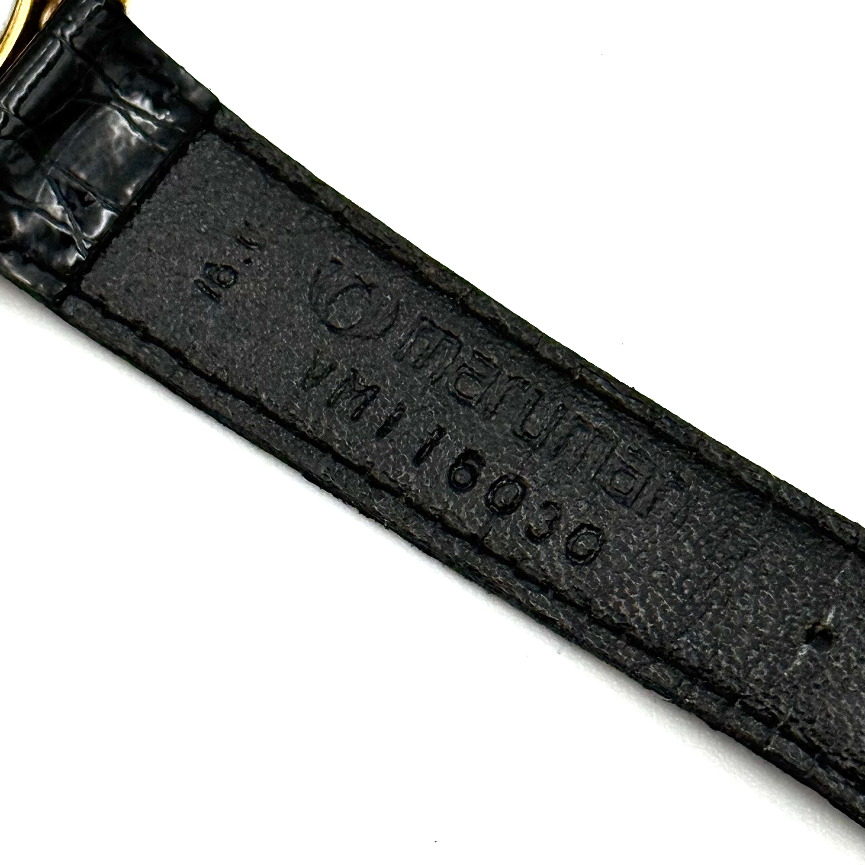 Seiko Avenue 7N01-6D50 gold watch with black textured leather strap displayed on a black cushion.