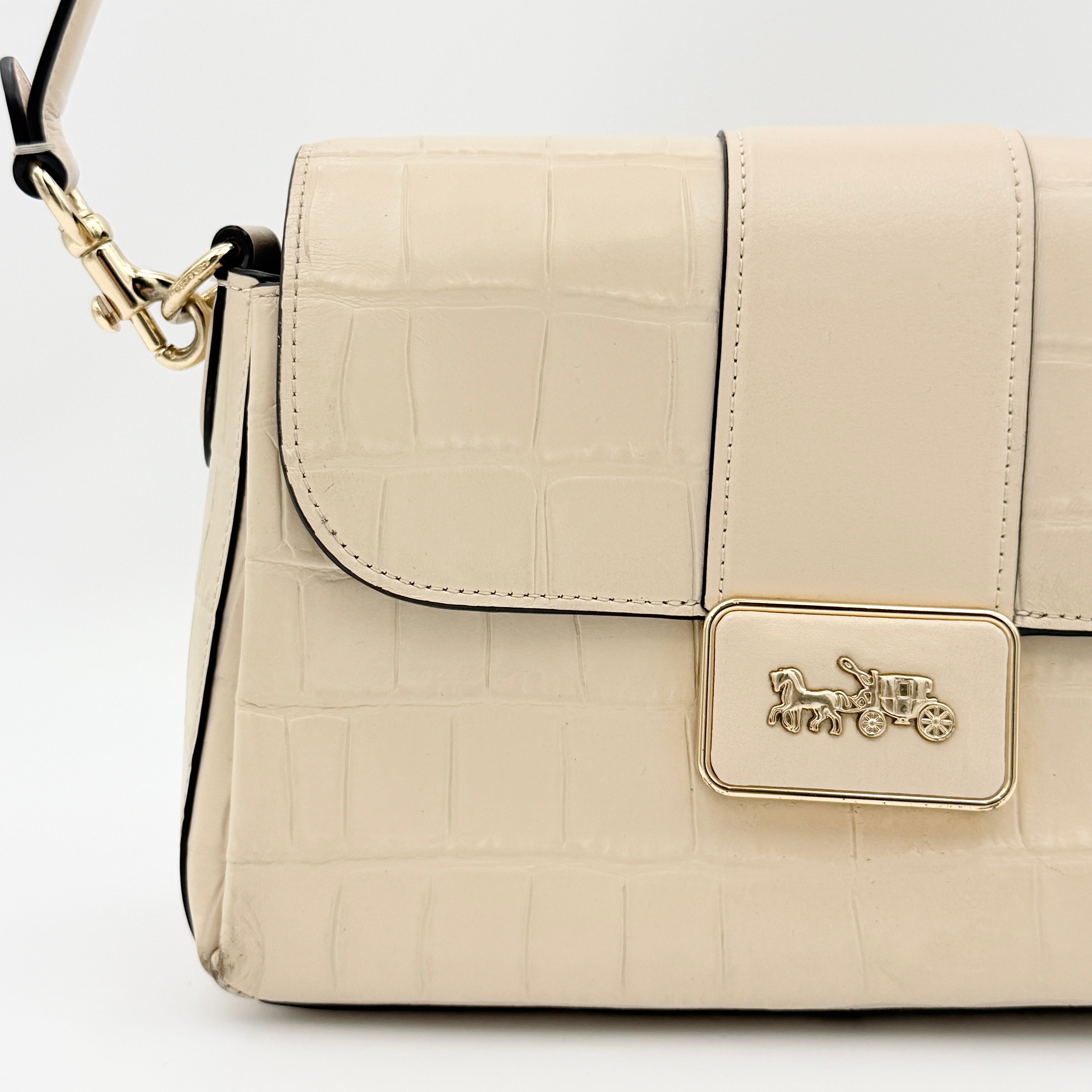 Coach Grace Shoulder Bag in ivory croc-embossed leather with gold-tone carriage plaque and structured shoulder strap.