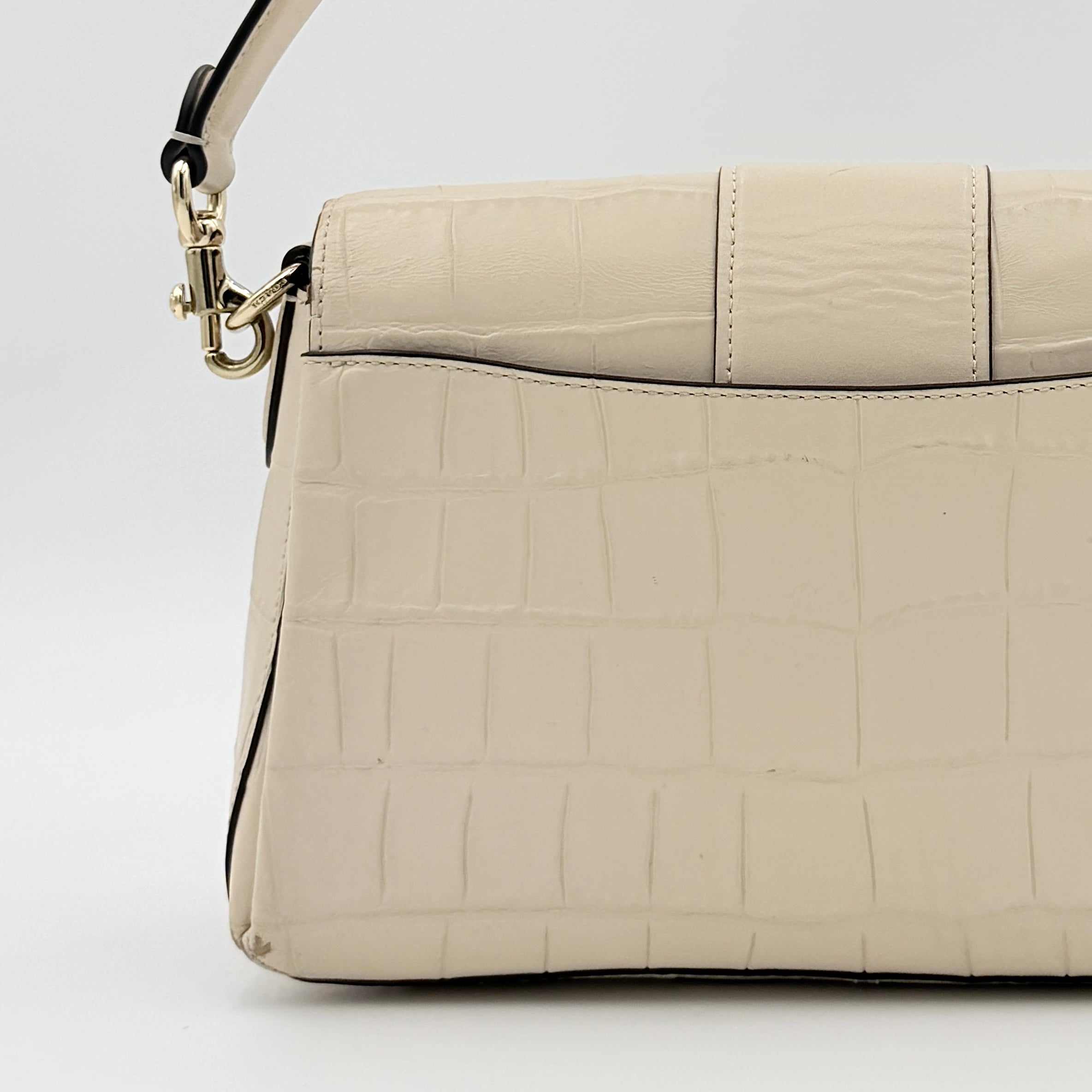 Coach Grace Shoulder Bag in ivory croc-embossed leather with gold-tone carriage plaque and structured shoulder strap.