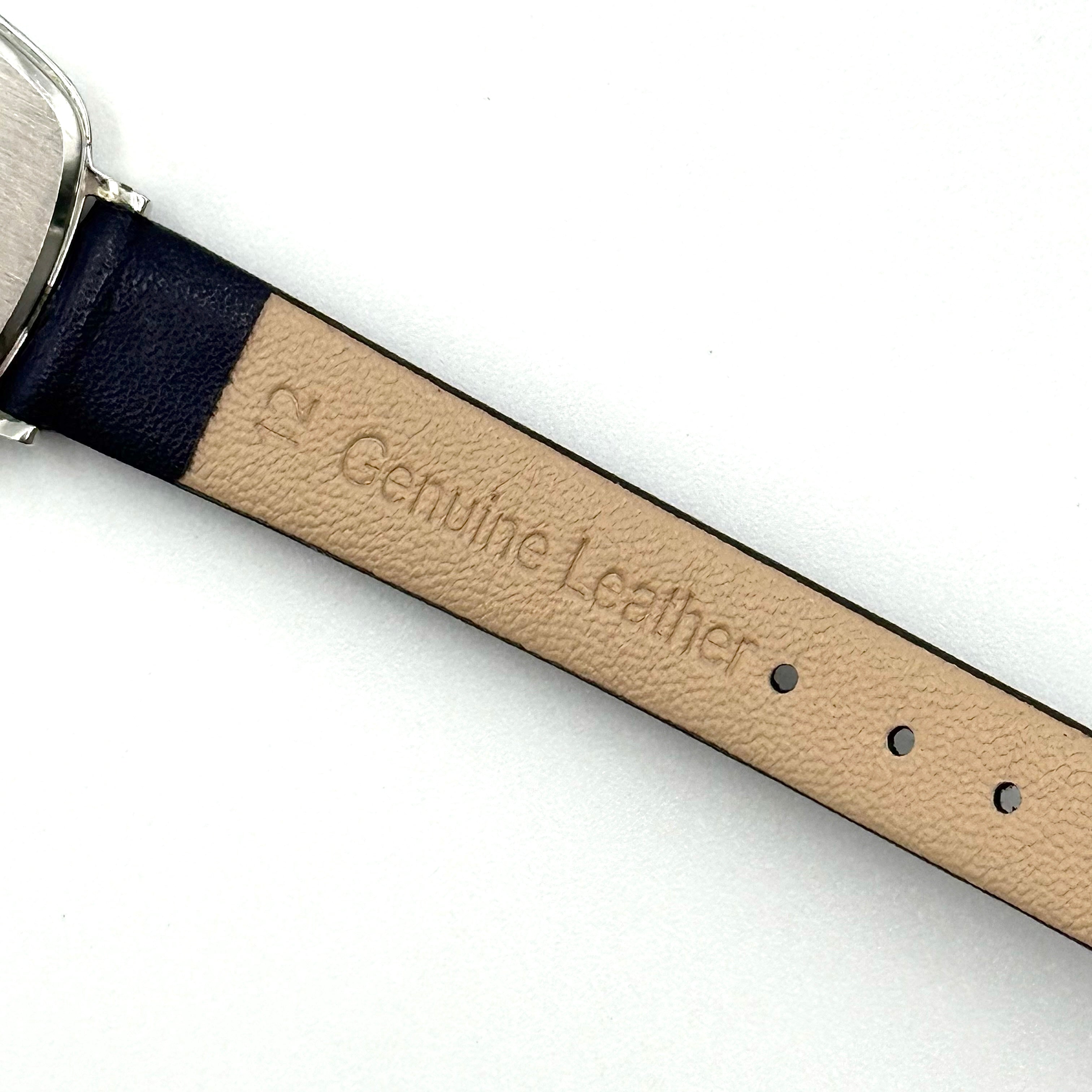 Seiko Quartz 2320-5270 with a square stainless steel case, copper dial, and navy blue leather strap displayed on a textured cushion.