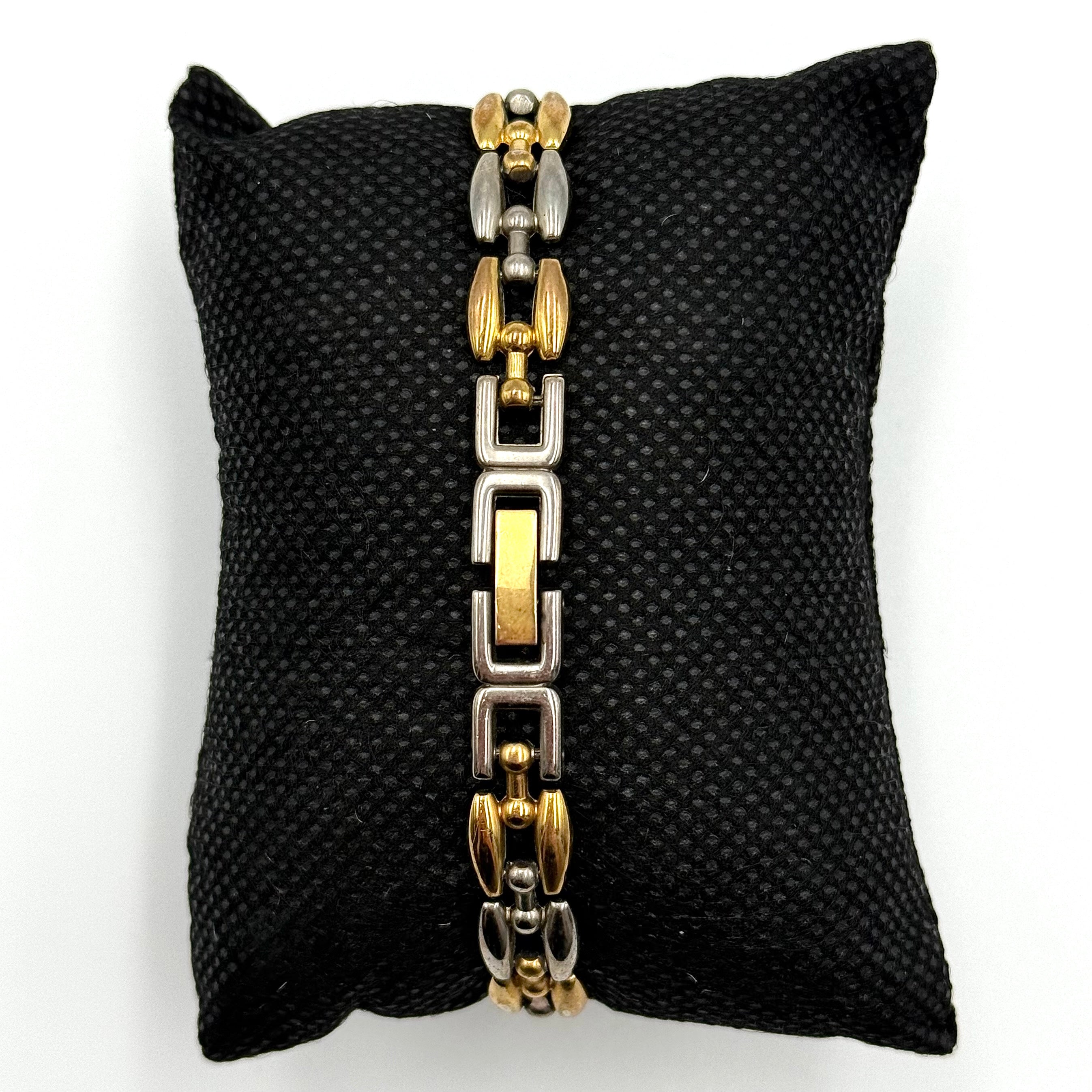 Citizen Free Way two-tone quartz watch with gold and silver link bracelet displayed on a black cushion.