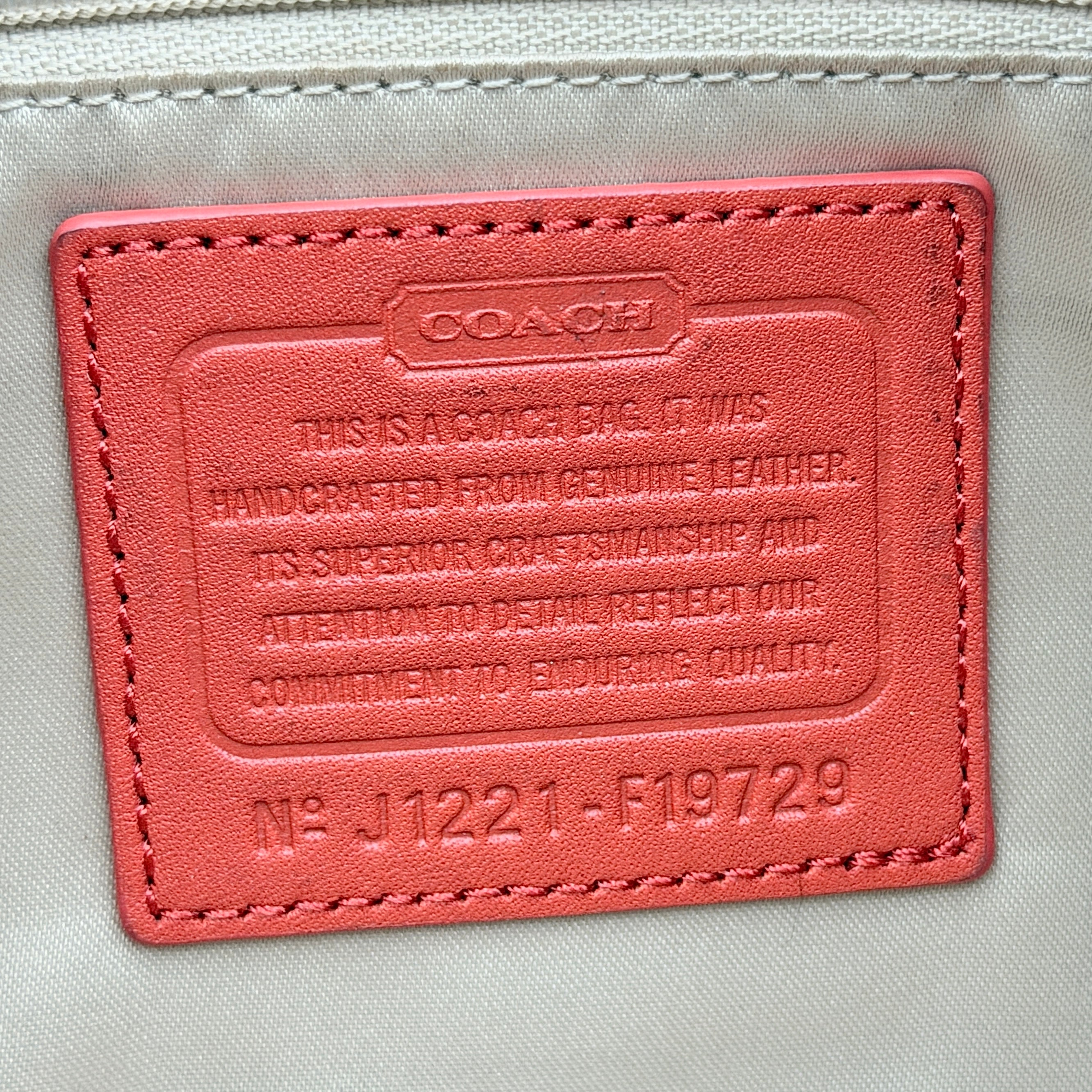 Coach 2Way Park Shoulder Bag in orange leather with gold hardware and adjustable strap, displayed against a white background.