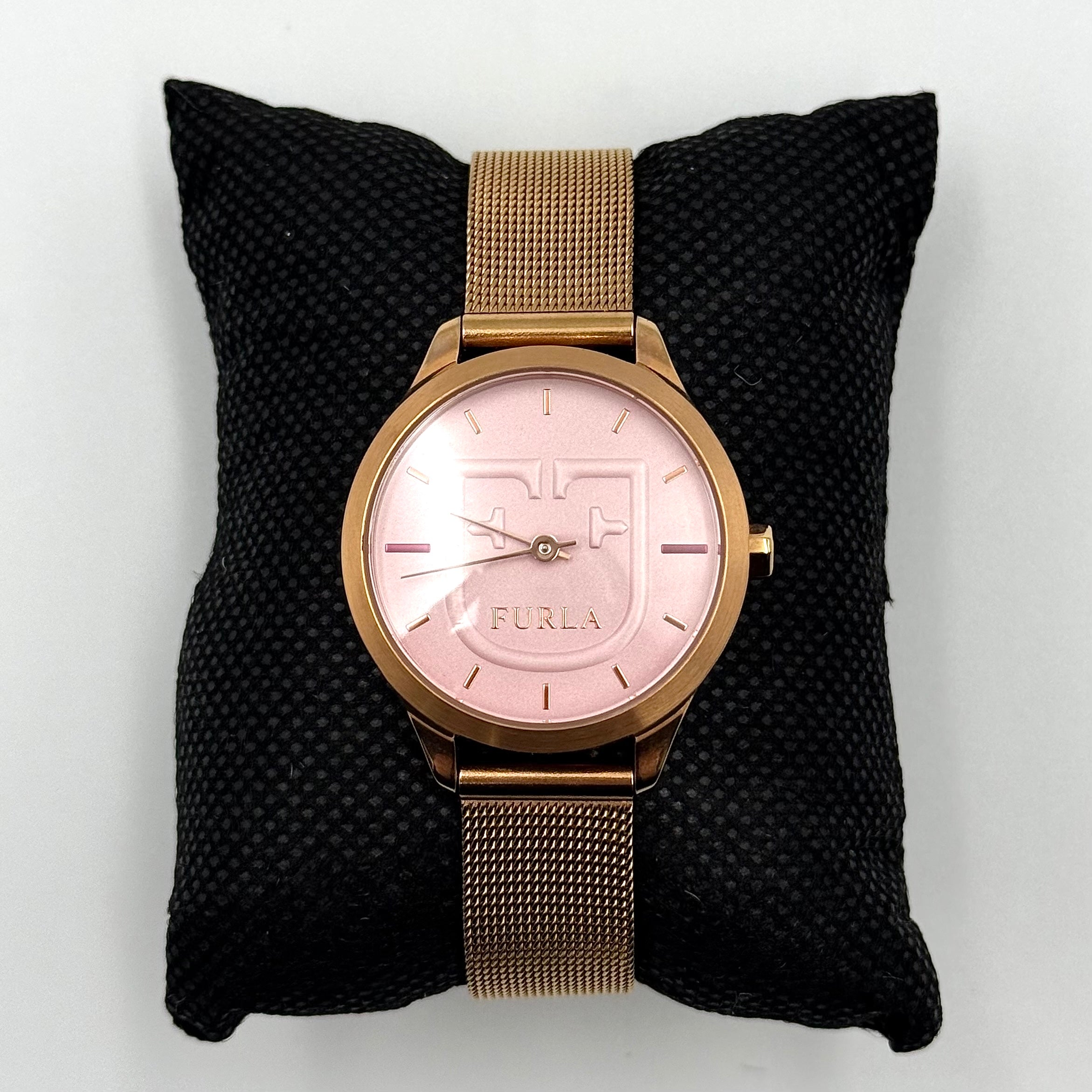 Furla WR 5 ATM watch with pink dial and rose gold Milanese mesh strap displayed on a black cushion.