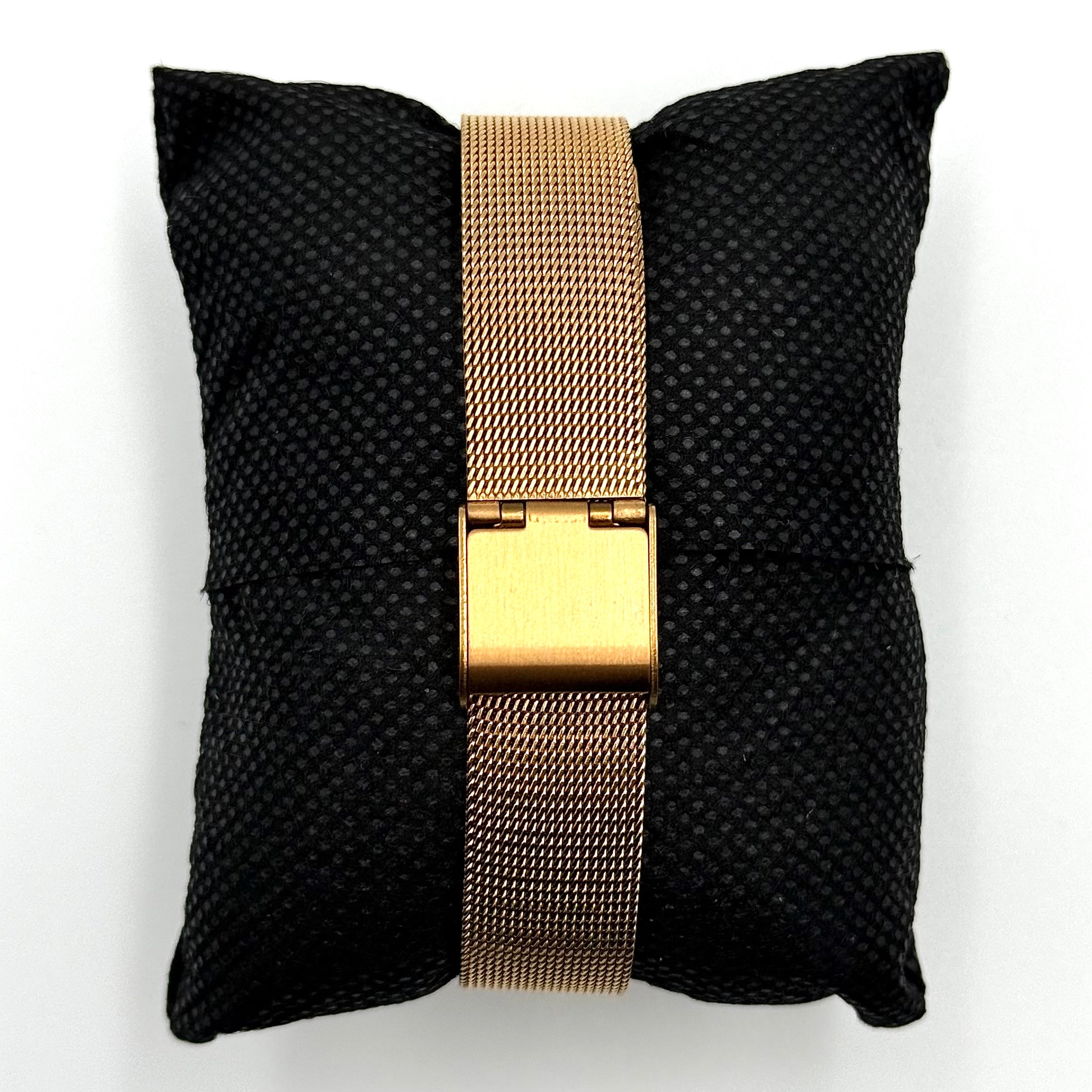 Furla WR 5 ATM watch with pink dial and rose gold Milanese mesh strap displayed on a black cushion.