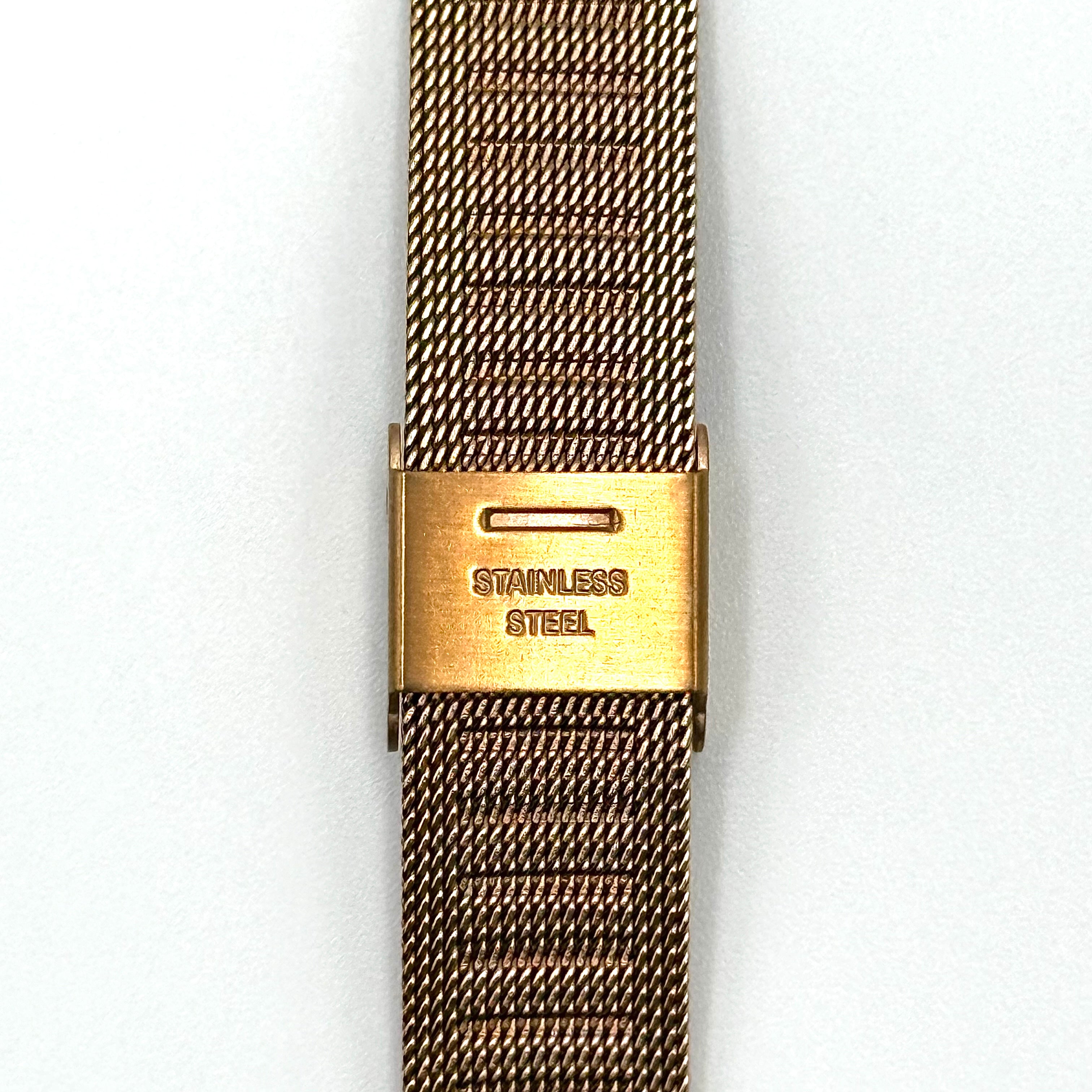 Furla WR 5 ATM watch with pink dial and rose gold Milanese mesh strap displayed on a black cushion.