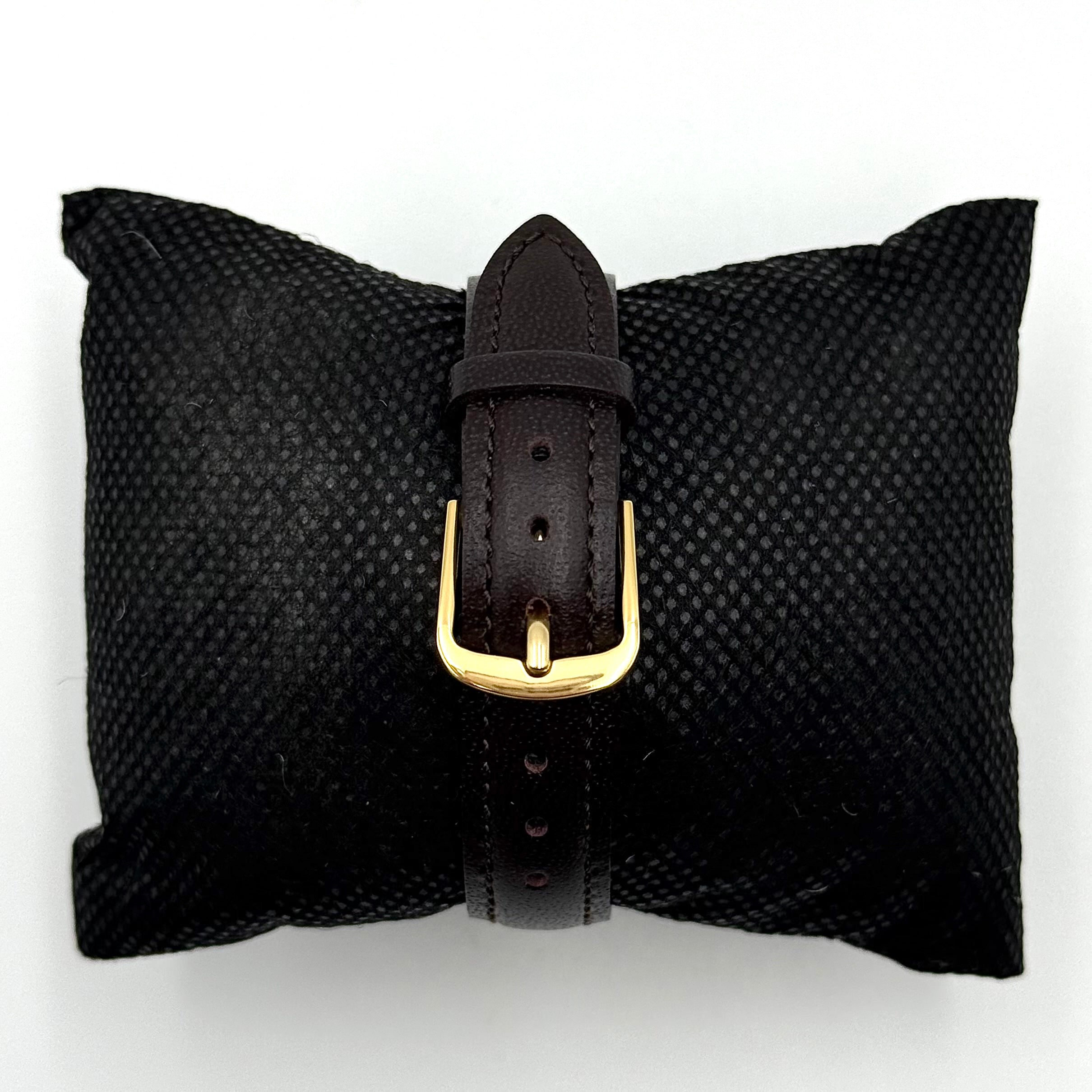Citizen Freeway gold-tone quartz watch with black leather strap on a textured cushion