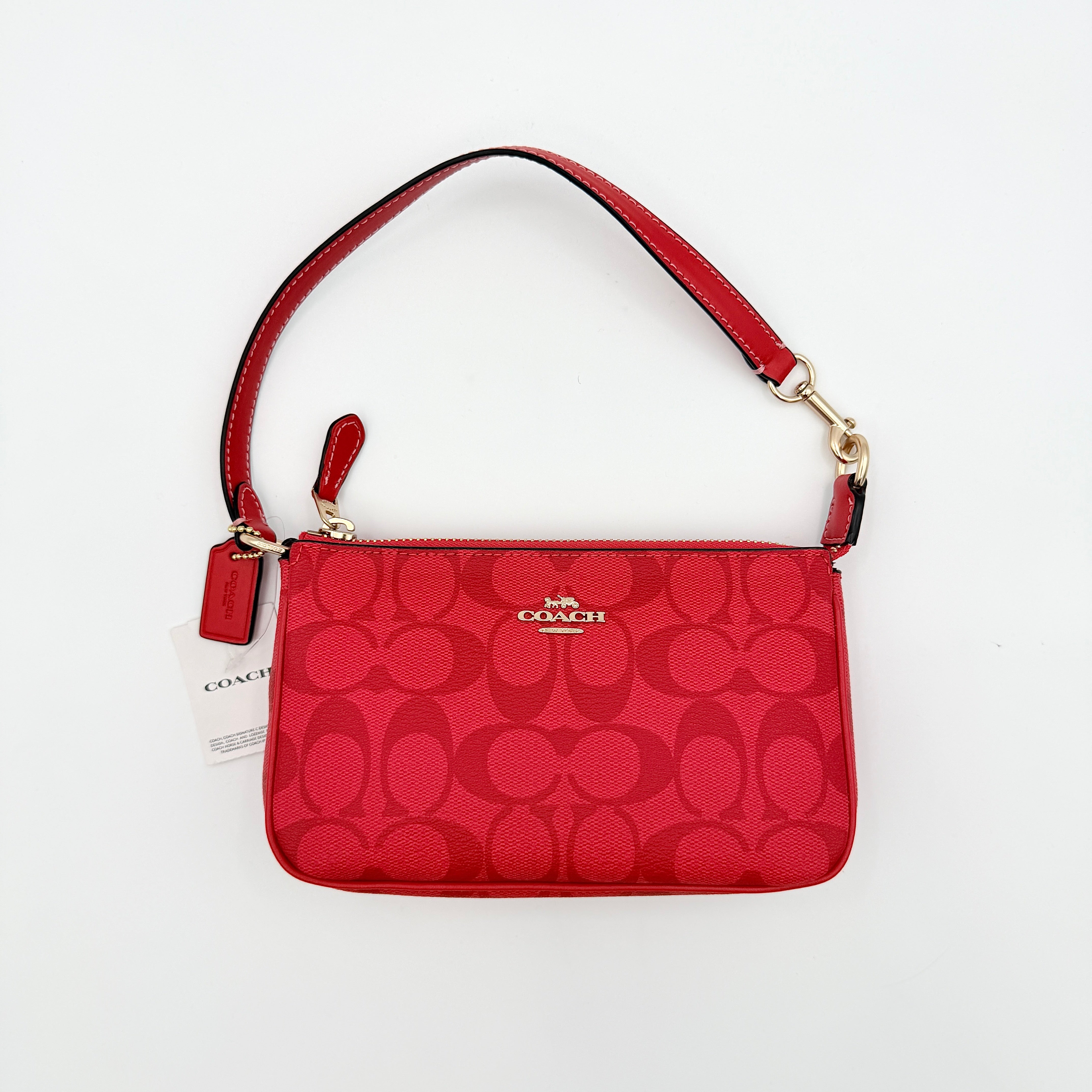 Coach Signature Nolita 19 Shoulder Bag in bright red coated canvas with signature pattern, gold-tone hardware and matching red hangtag.