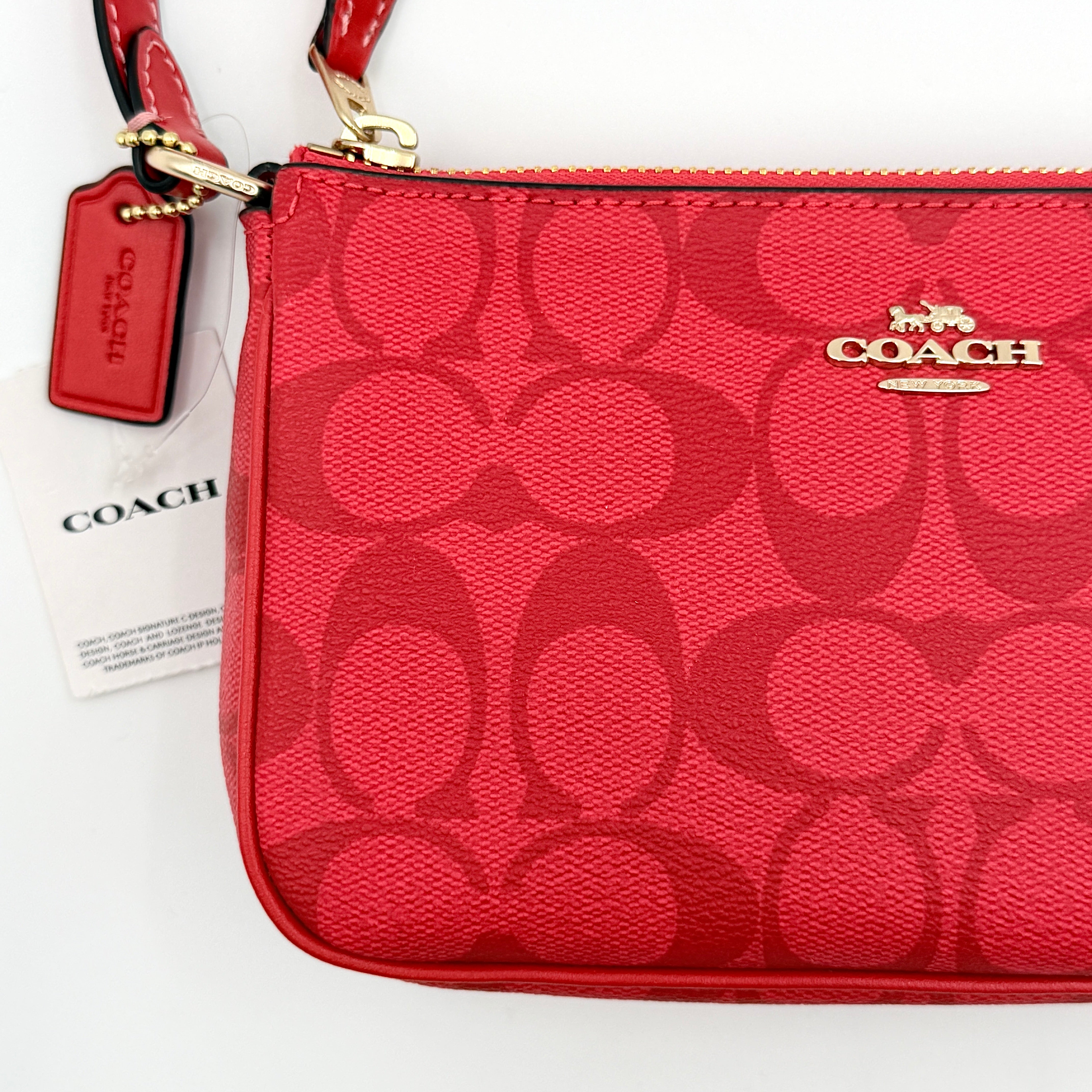 Coach Signature Nolita 19 Shoulder Bag in bright red coated canvas with signature pattern, gold-tone hardware and matching red hangtag.