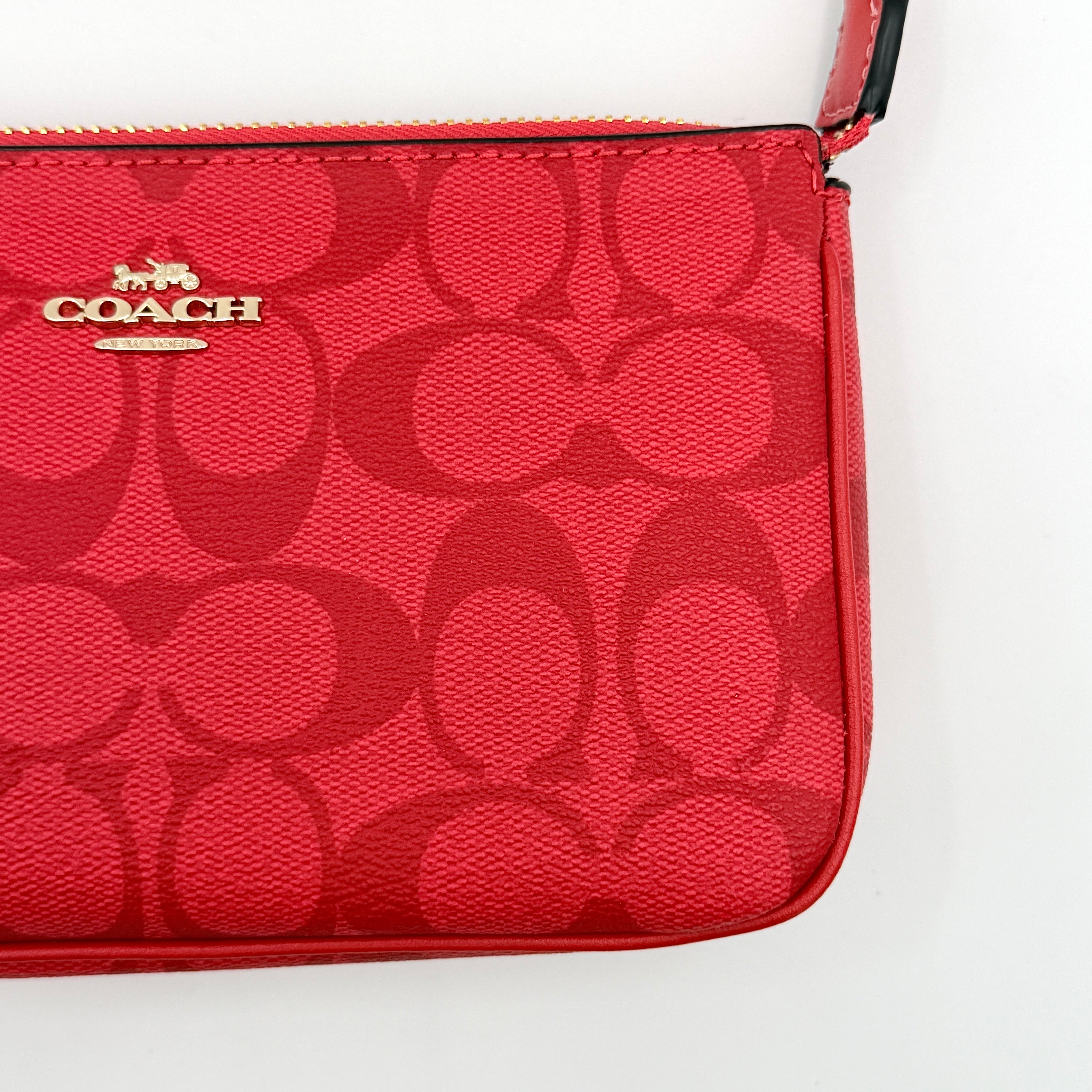 Coach Signature Nolita 19 Shoulder Bag in bright red coated canvas with signature pattern, gold-tone hardware and matching red hangtag.