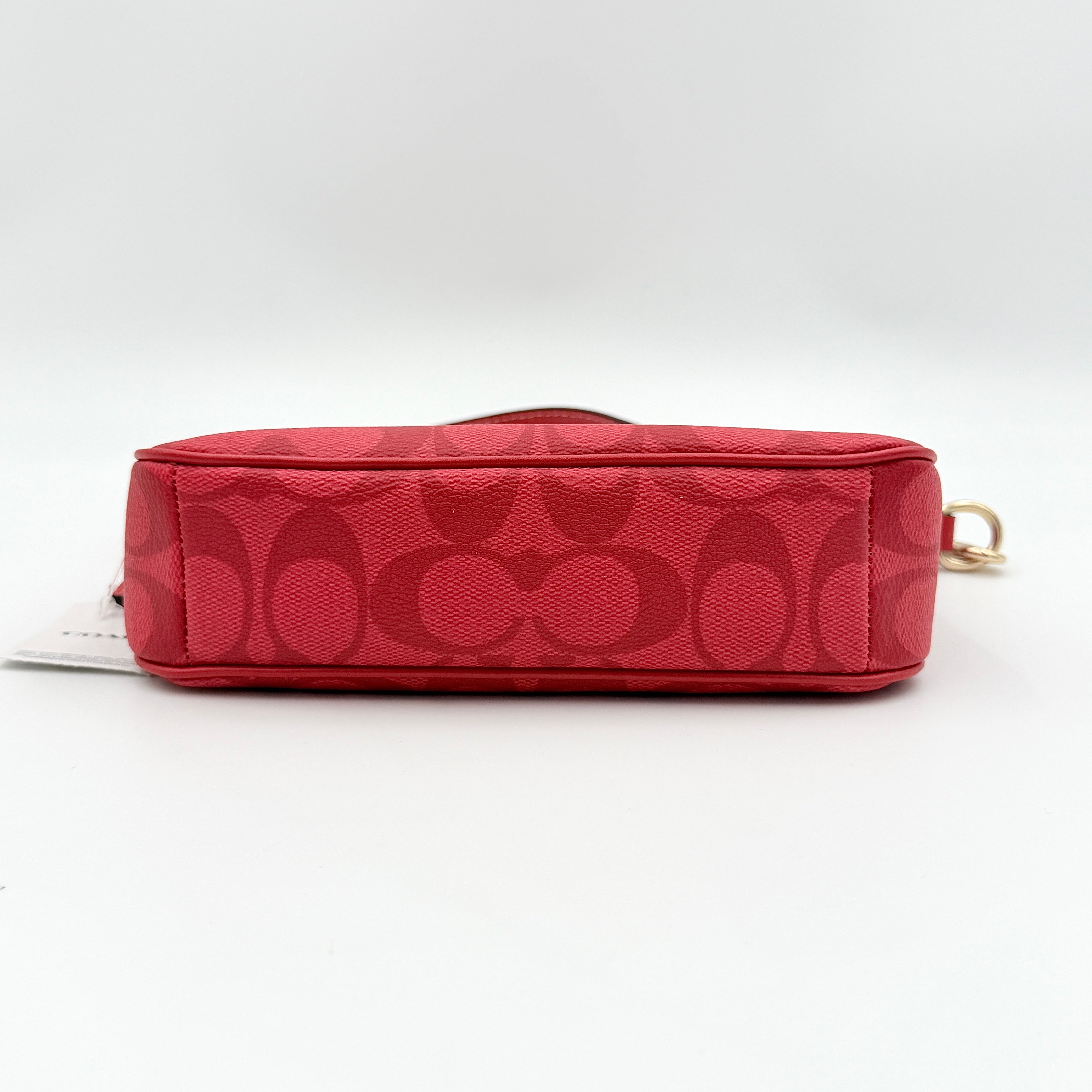 Coach Signature Nolita 19 Shoulder Bag in bright red coated canvas with signature pattern, gold-tone hardware and matching red hangtag.
