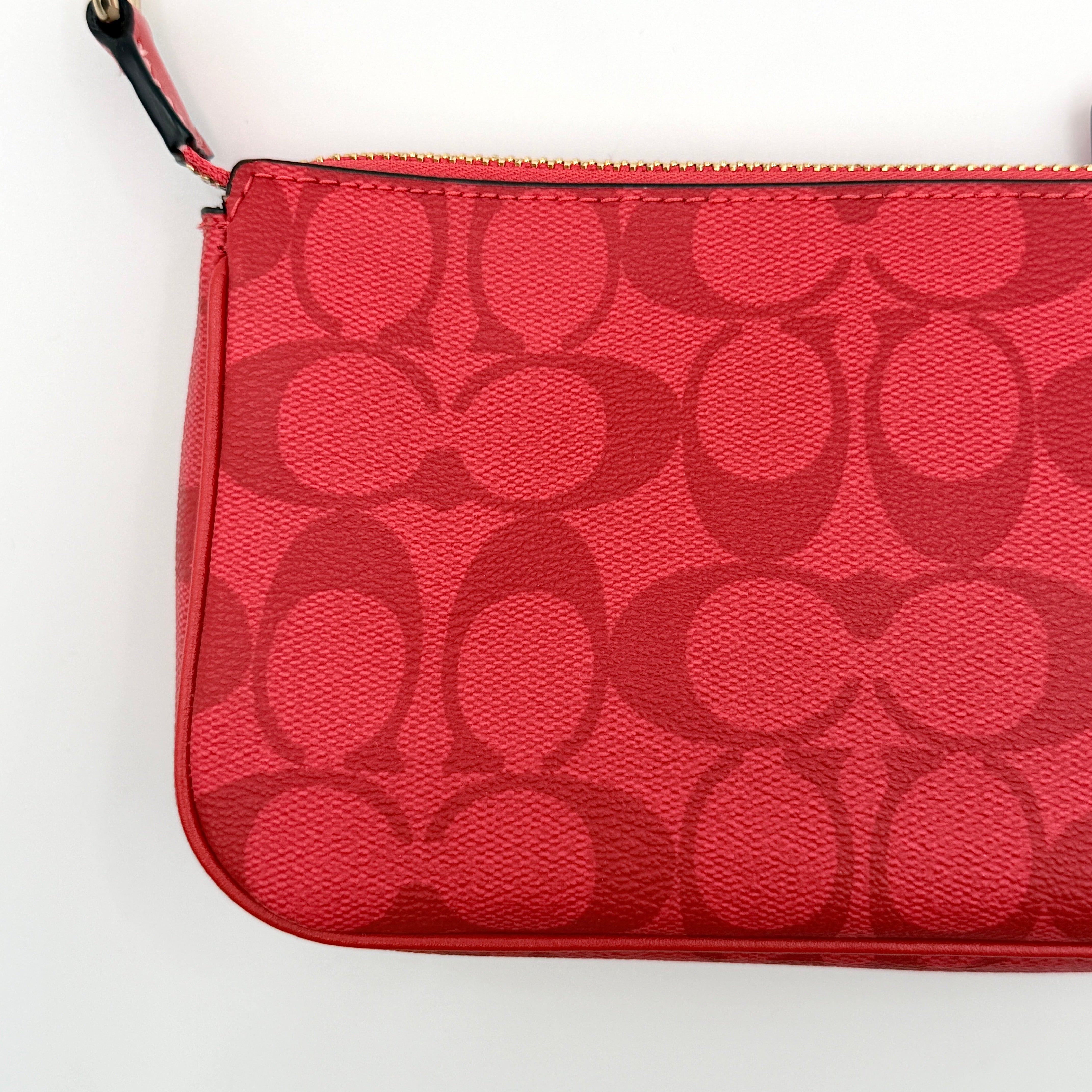 Coach Signature Nolita 19 Shoulder Bag in bright red coated canvas with signature pattern, gold-tone hardware and matching red hangtag.