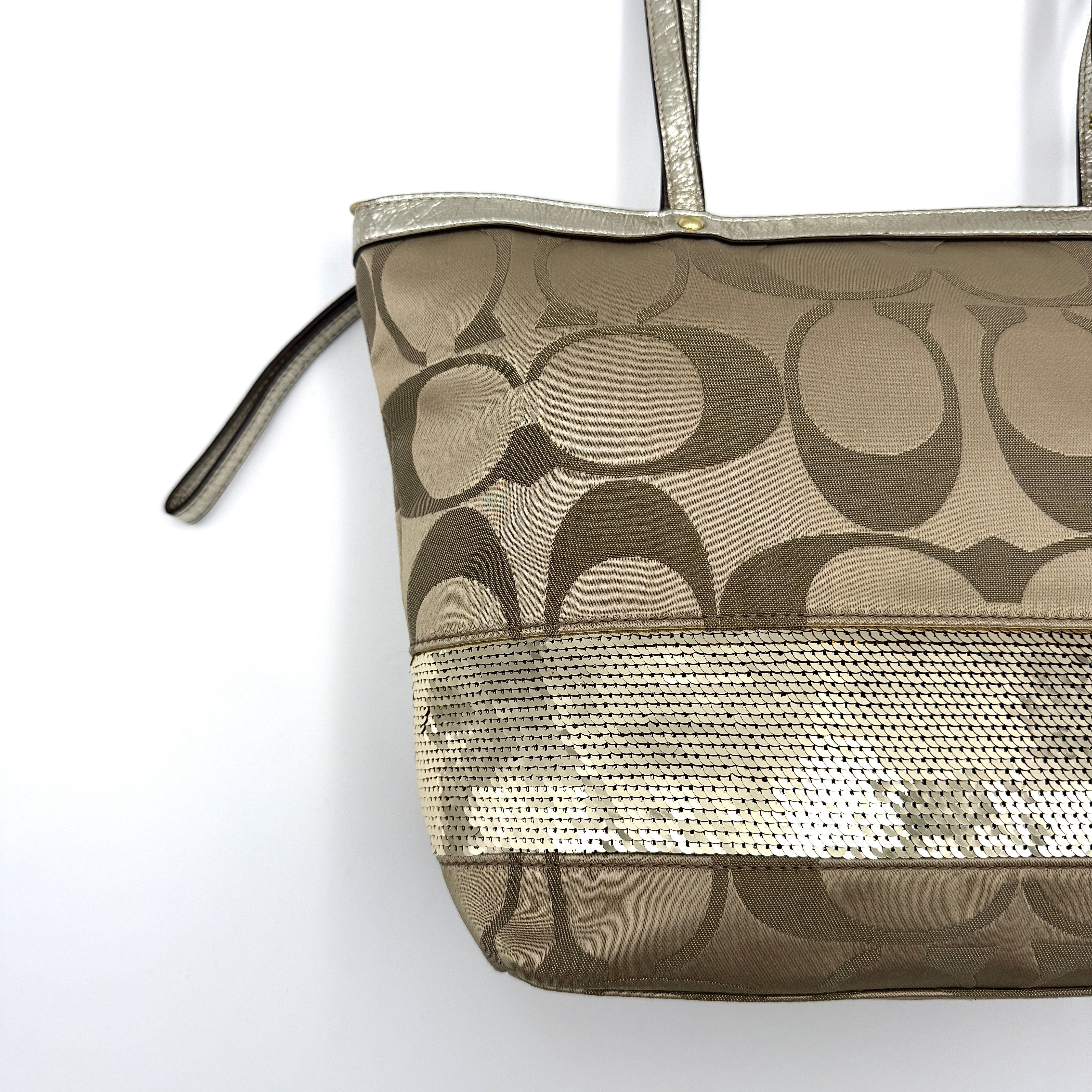 Coach Signature Stripe Tote Bag in gold and beige canvas with metallic gold leather trim and double handles.