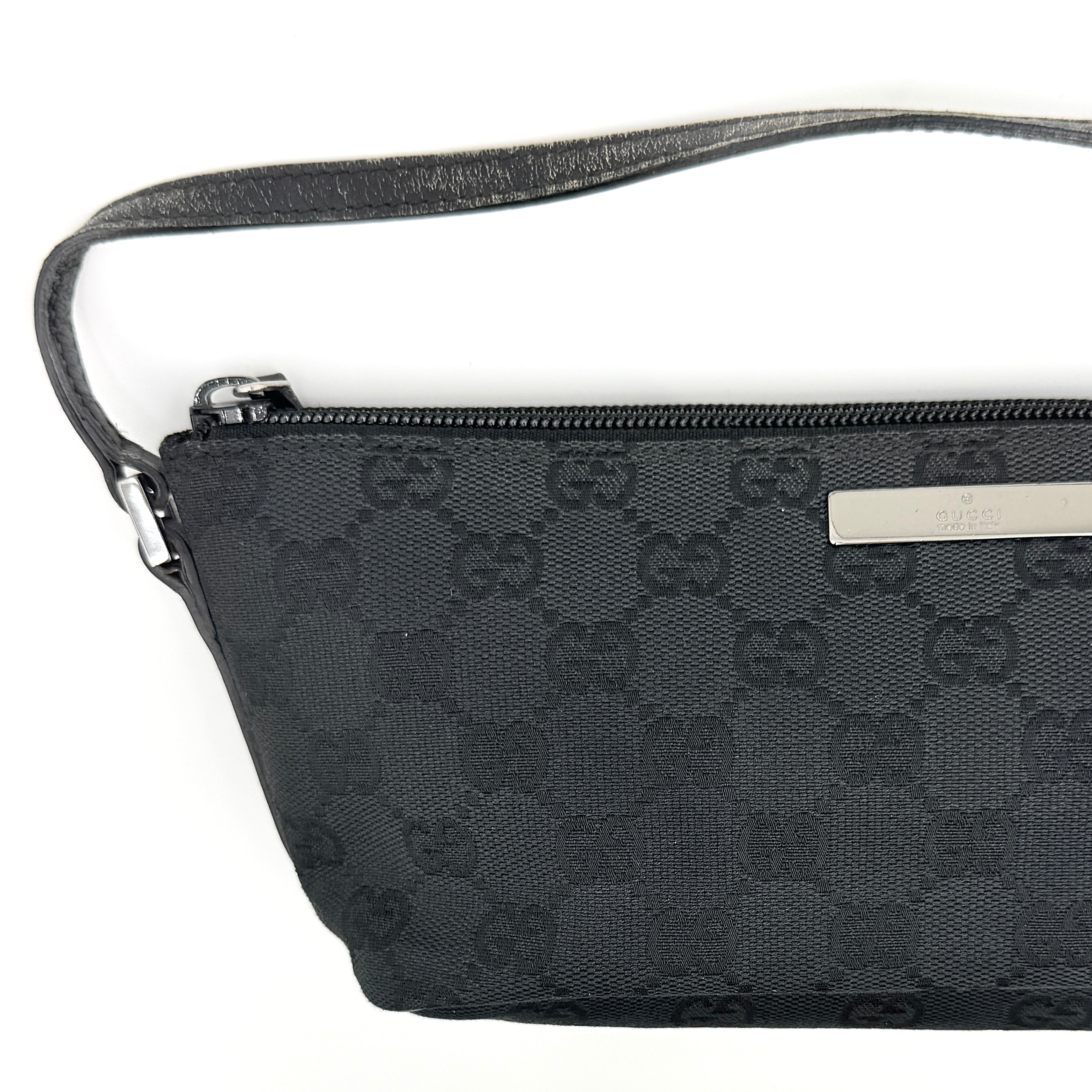 The Gucci GG Monogram Pochette Boat Shoulder Bag in black canvas with leather trim and silver-tone hardware, shown from the front with its structured, compact shape.