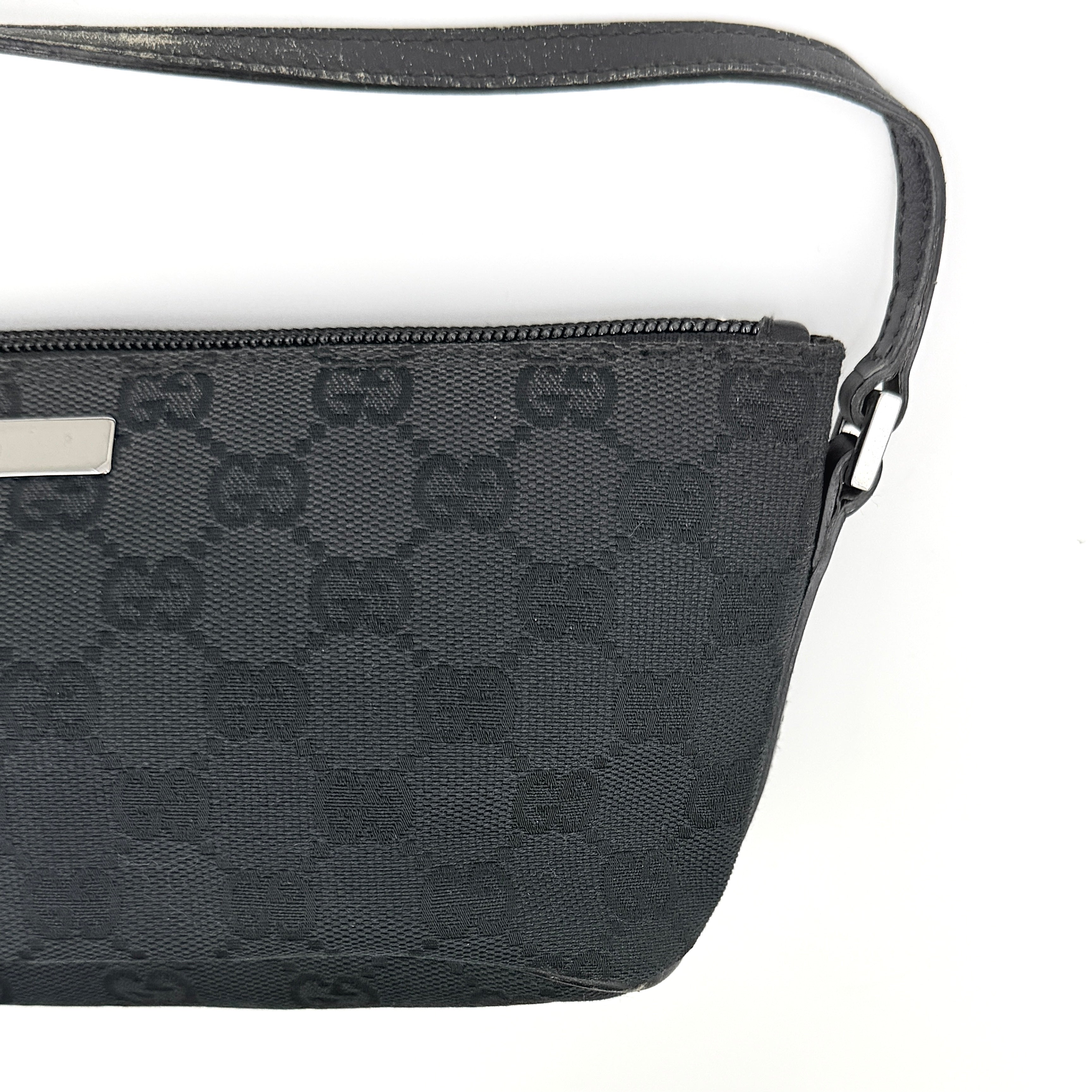 The Gucci GG Monogram Pochette Boat Shoulder Bag in black canvas with leather trim and silver-tone hardware, shown from the front with its structured, compact shape.