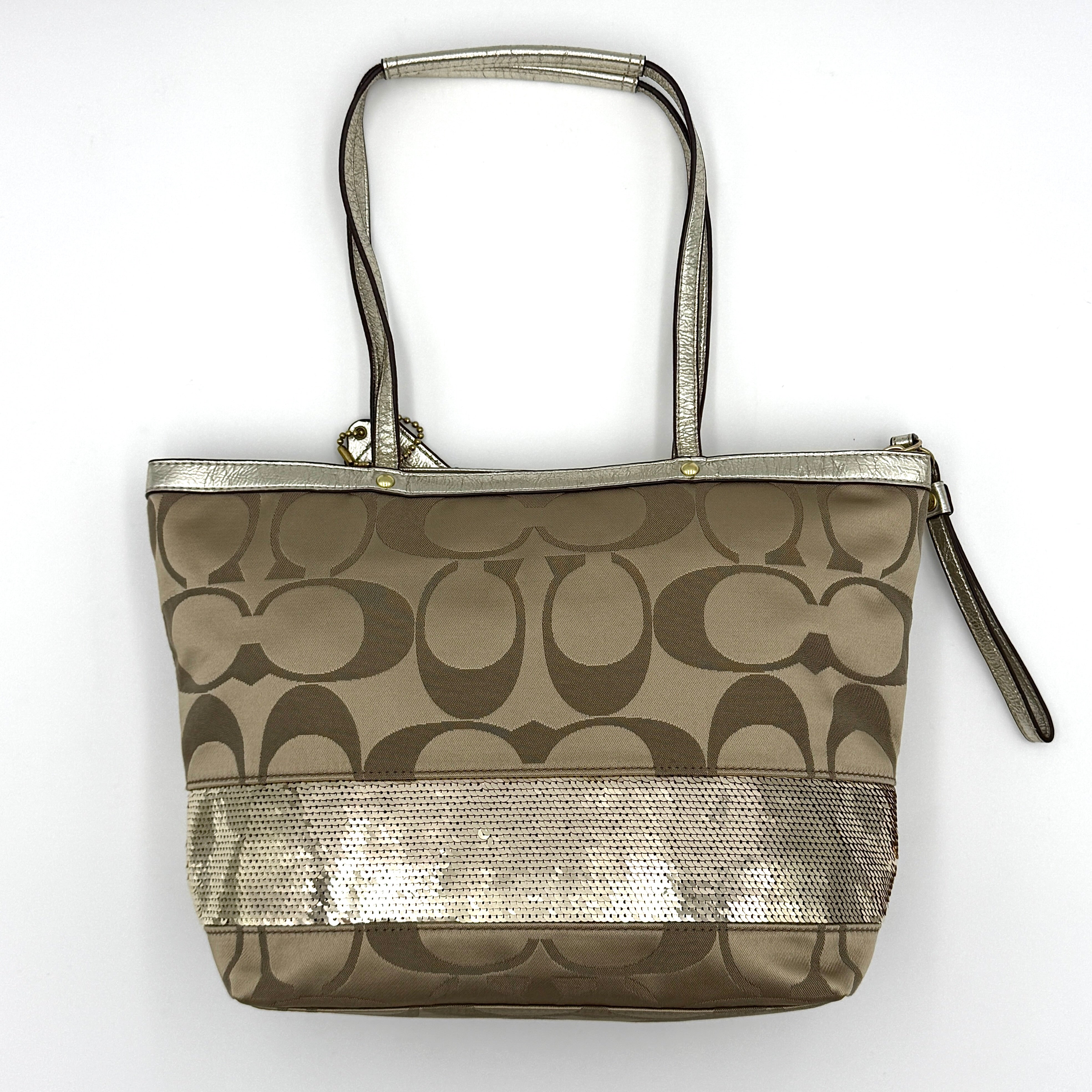 Coach Signature Stripe Tote Bag in gold and beige canvas with metallic gold leather trim and double handles.