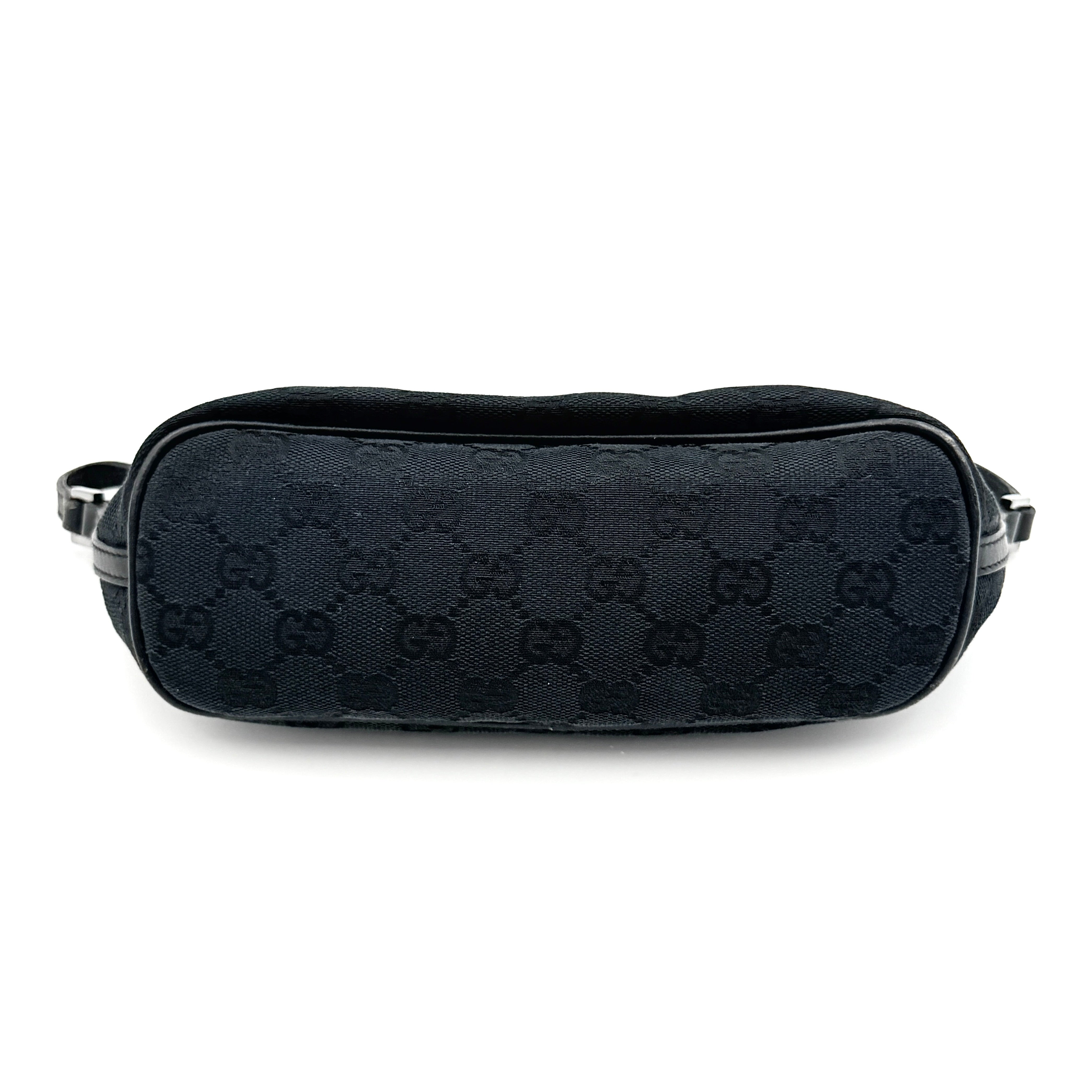 The Gucci GG Monogram Pochette Boat Shoulder Bag in black canvas with leather trim and silver-tone hardware, shown from the front with its structured, compact shape.
