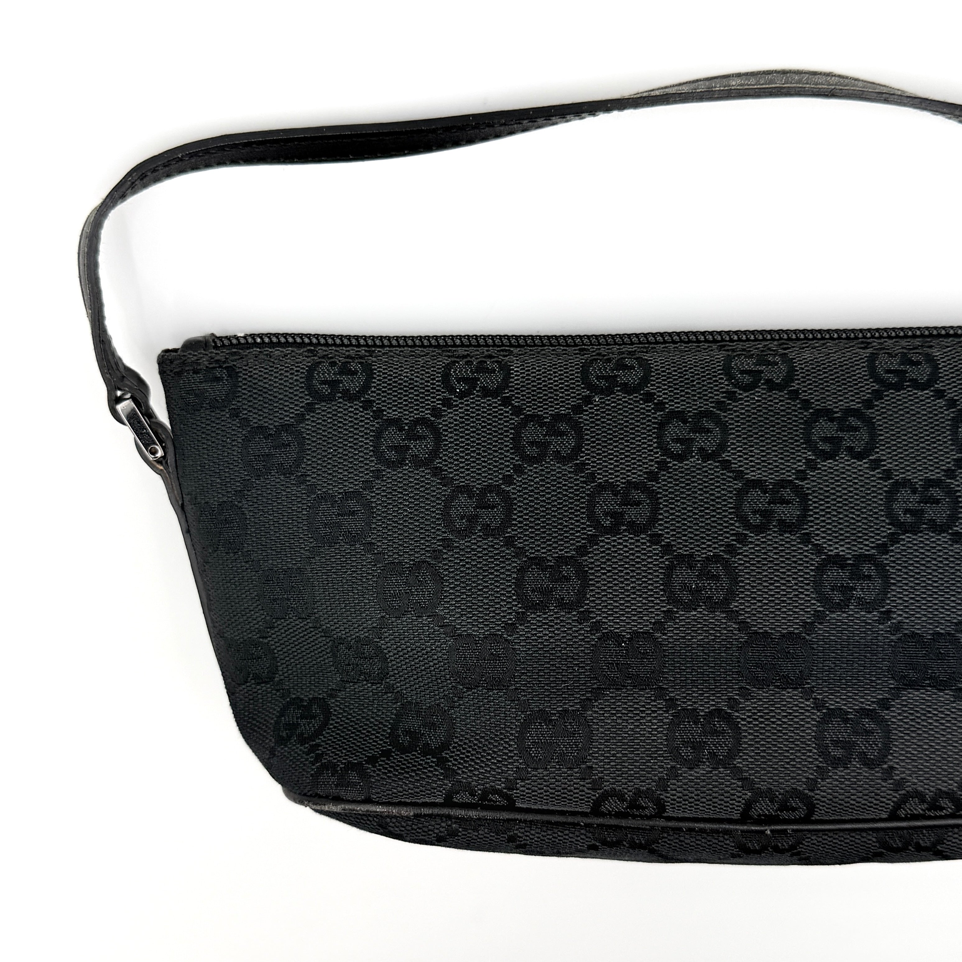 The Gucci GG Monogram Pochette Boat Shoulder Bag in black canvas with leather trim and silver-tone hardware, shown from the front with its structured, compact shape.
