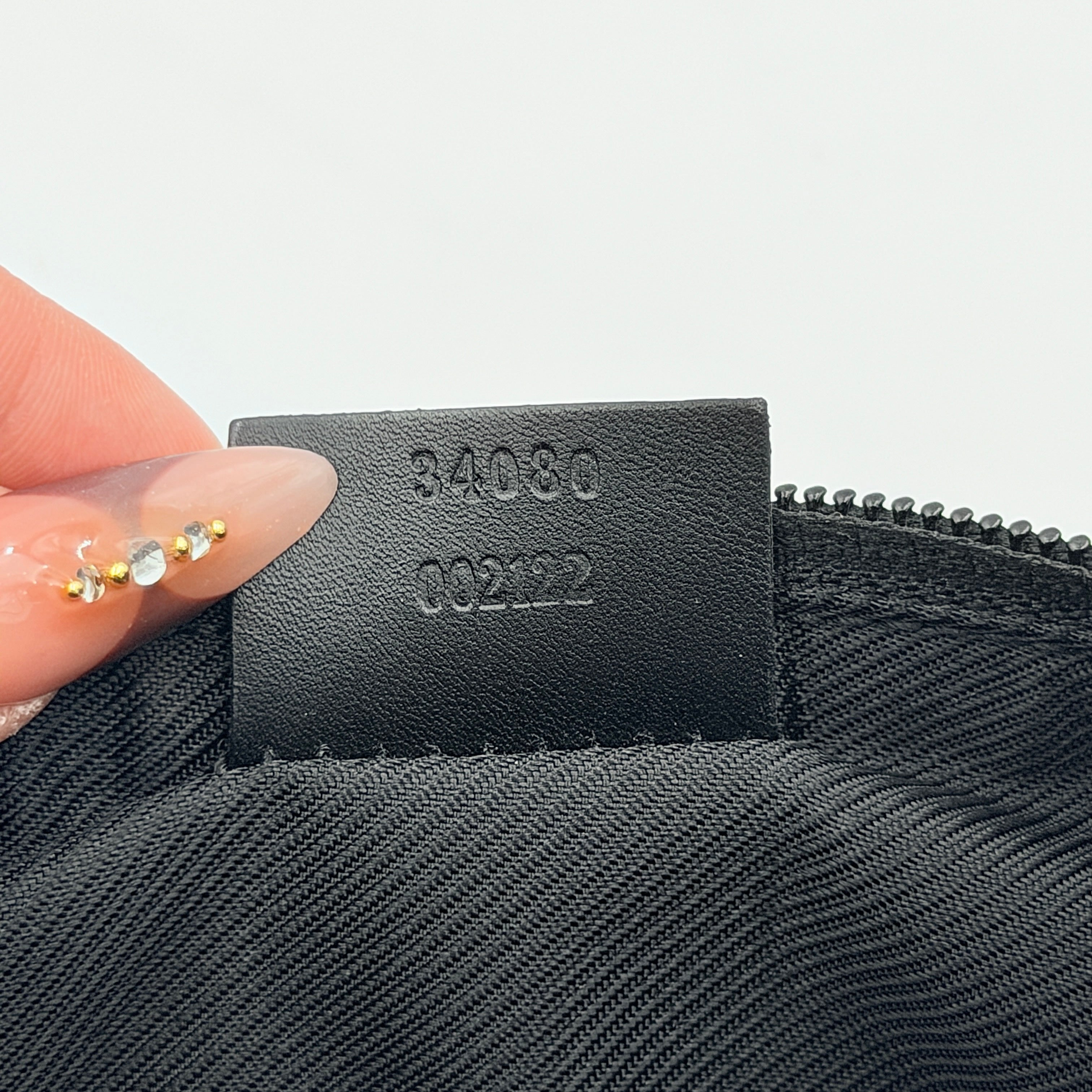 The Gucci GG Monogram Pochette Boat Shoulder Bag in black canvas with leather trim and silver-tone hardware, shown from the front with its structured, compact shape.