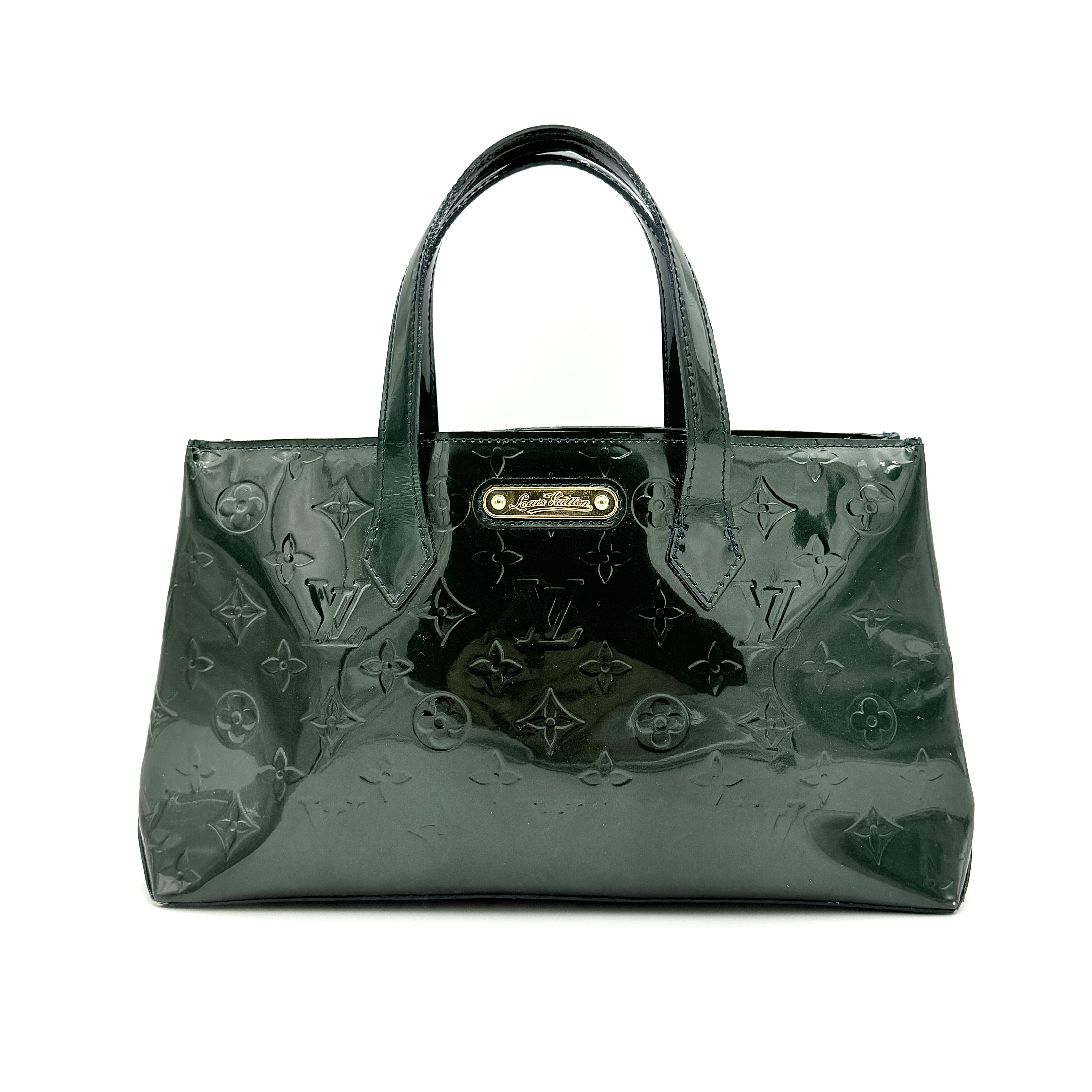 Louis Vuitton Wilshire PM bag in glossy dark green Monogram Vernis patent leather, shown with double top handles and gold-tone nameplate.