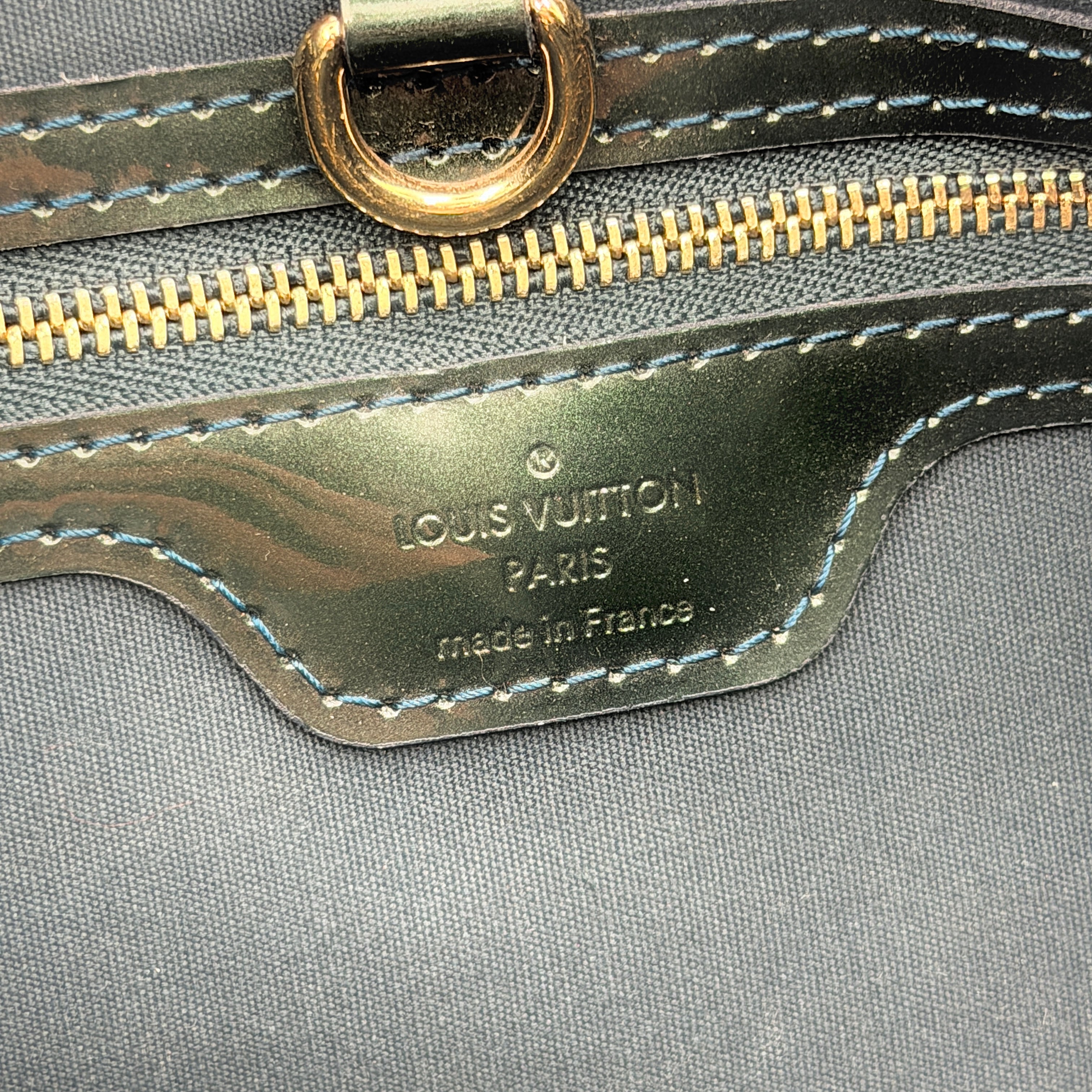 Louis Vuitton Wilshire PM bag in glossy dark green Monogram Vernis patent leather, shown with double top handles and gold-tone nameplate.