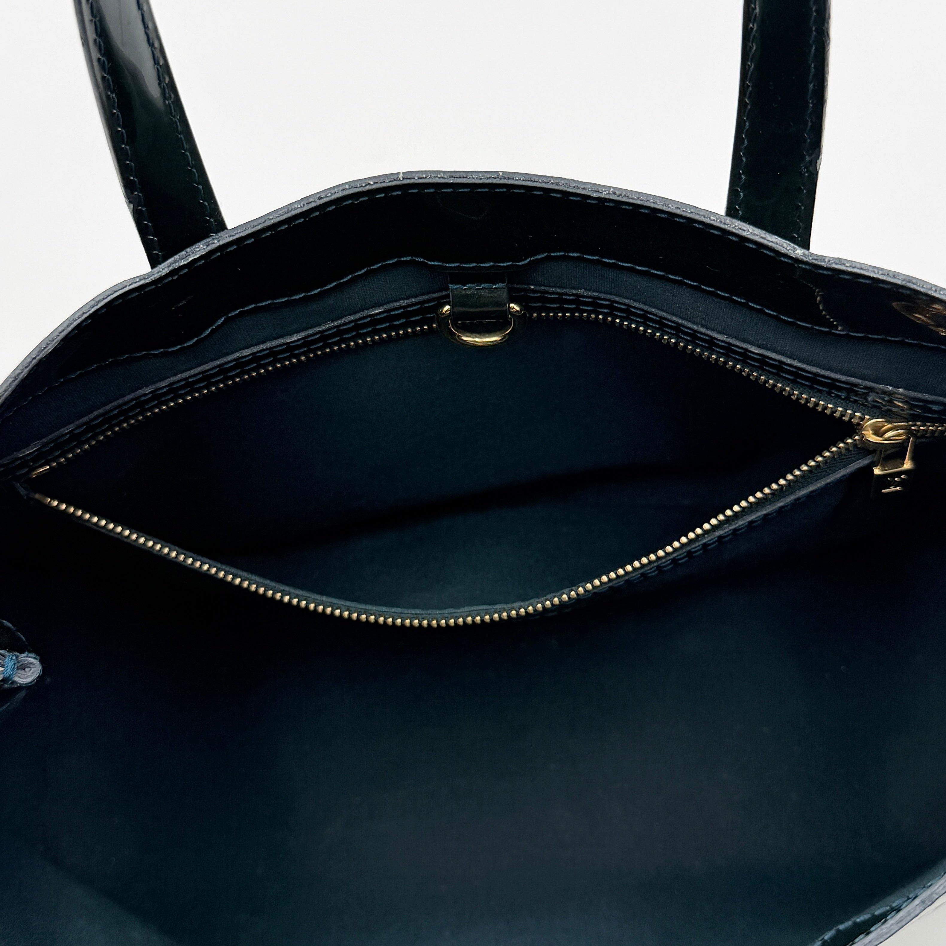 Louis Vuitton Wilshire PM bag in glossy dark green Monogram Vernis patent leather, shown with double top handles and gold-tone nameplate.