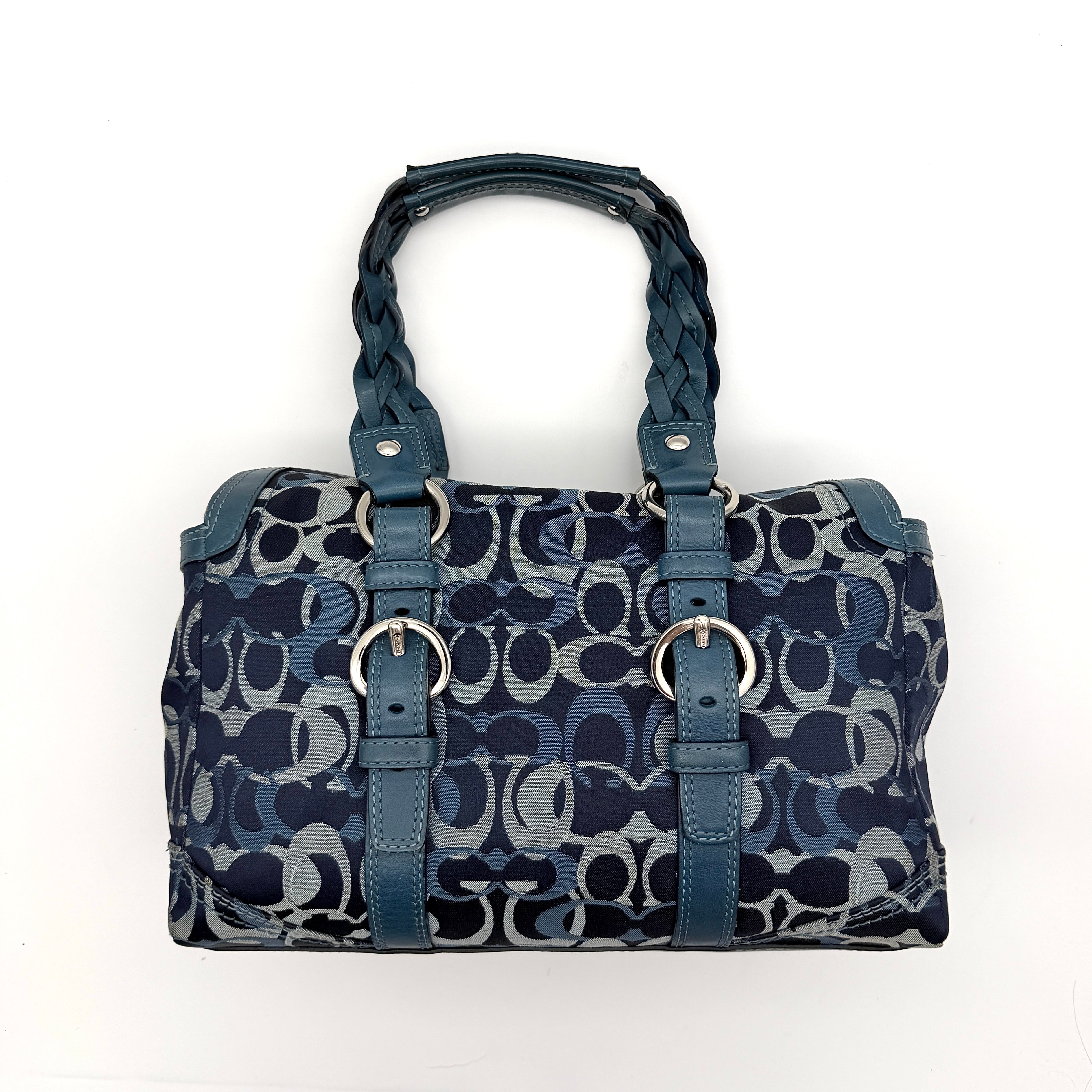 Coach Signature Chelsea Optic Satchel in blue canvas with leather braided handles and silver hardware, displayed on a Coach dust bag.