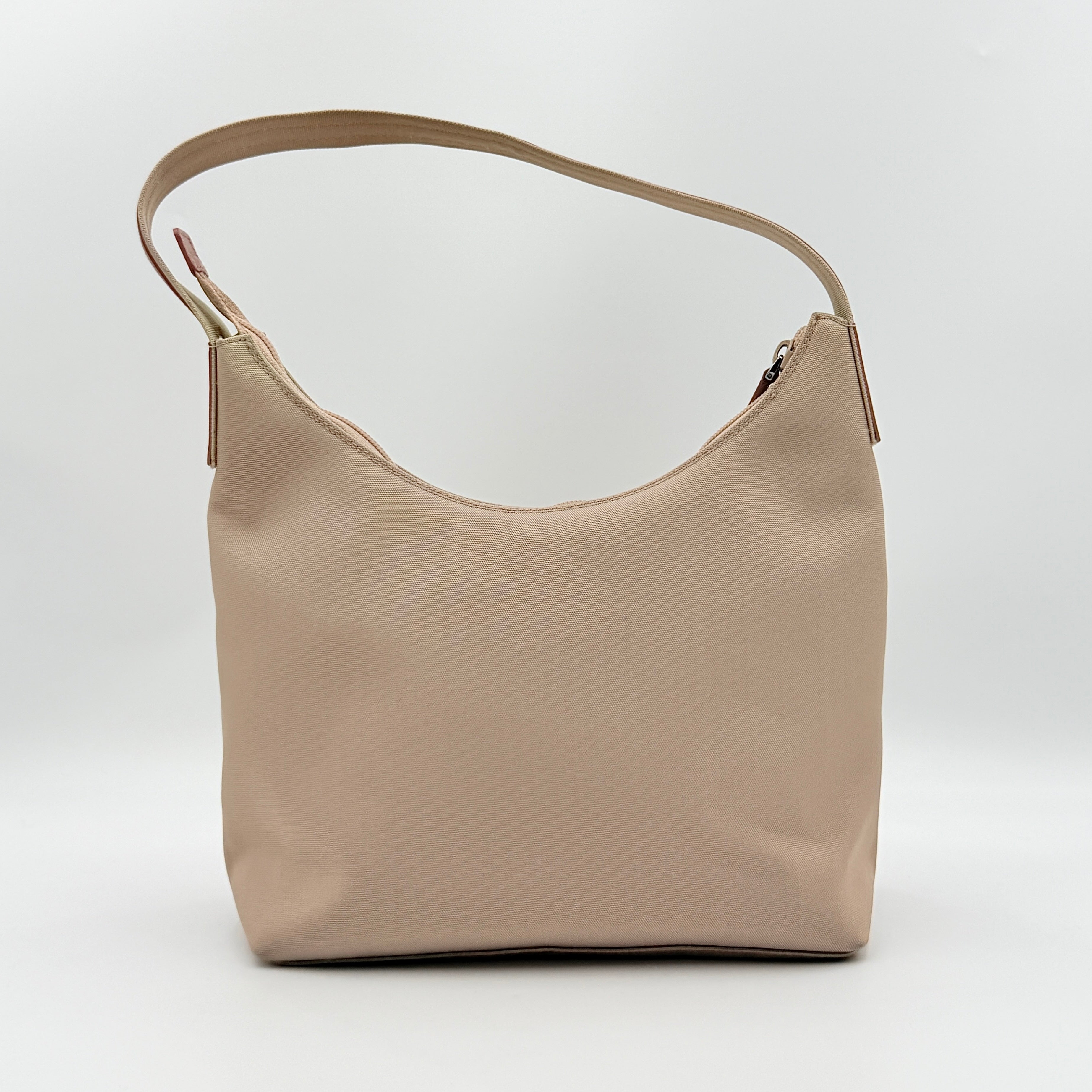 Gucci beige canvas hobo shoulder bag with pink leather accents and silver-tone hardware, displayed front-facing on a white background.