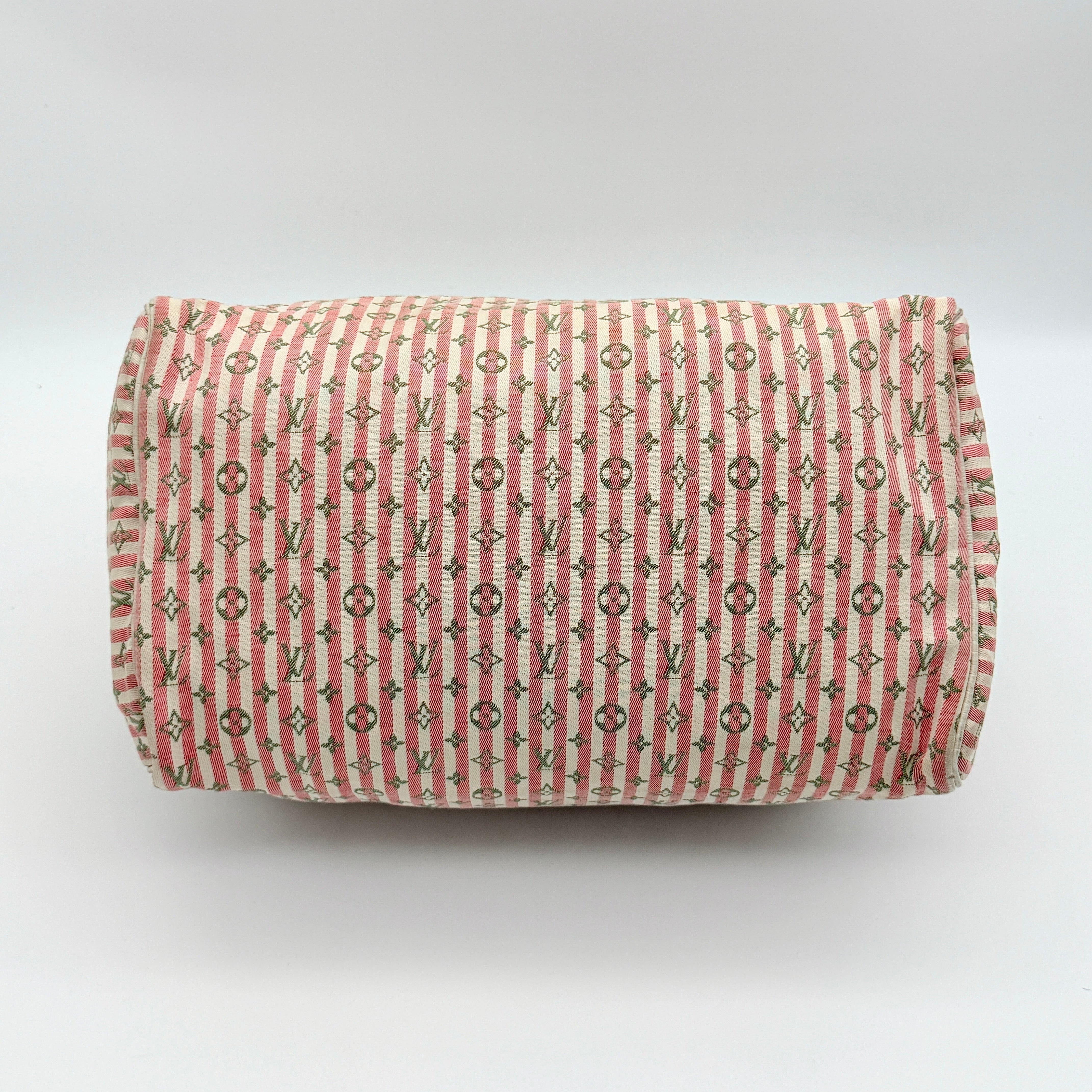 Louis Vuitton Speedy 30 in pink Mini Lin Monogram with cream leather handles and gold-tone zip, displayed on a neutral background.