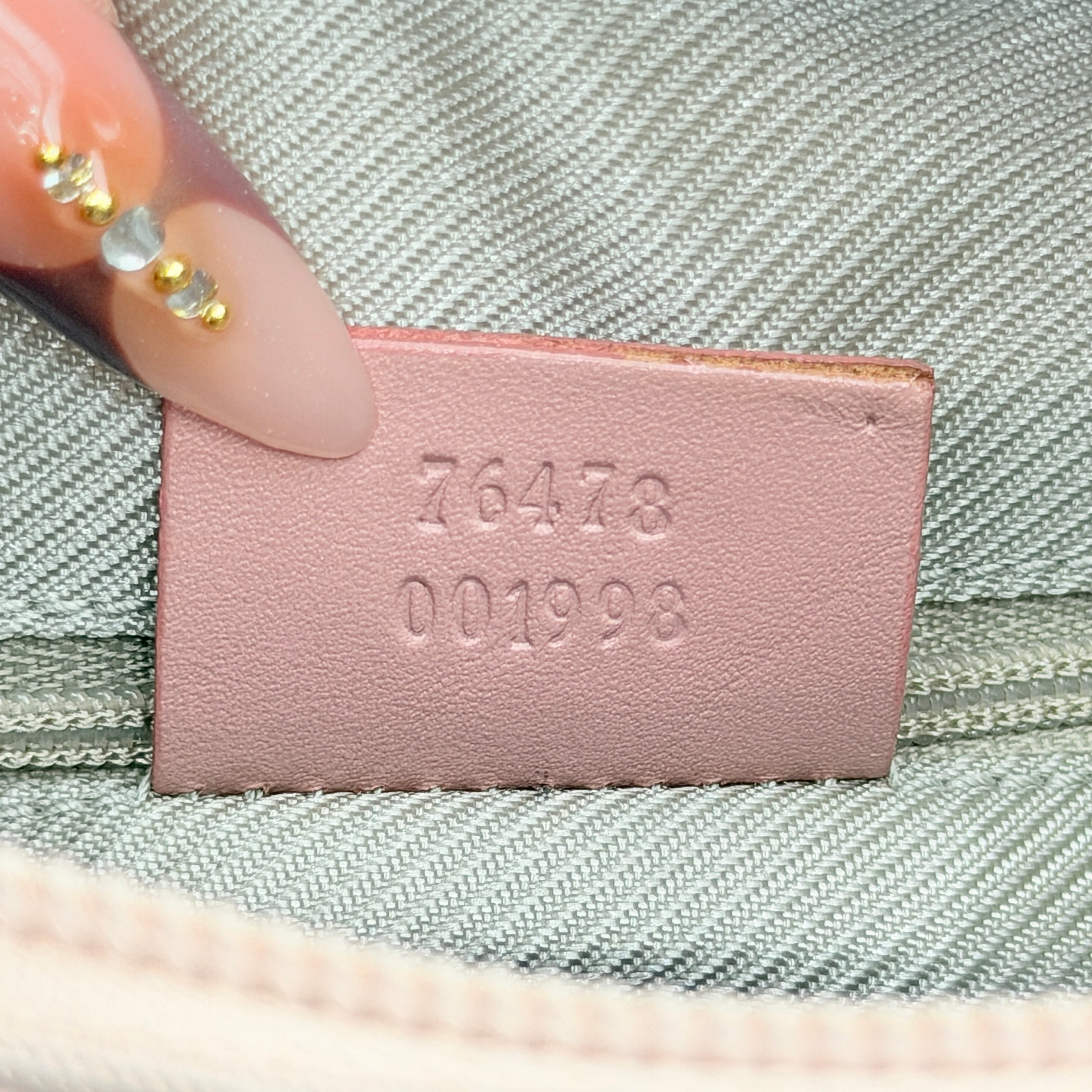 Gucci beige canvas hobo shoulder bag with pink leather accents and silver-tone hardware, displayed front-facing on a white background.