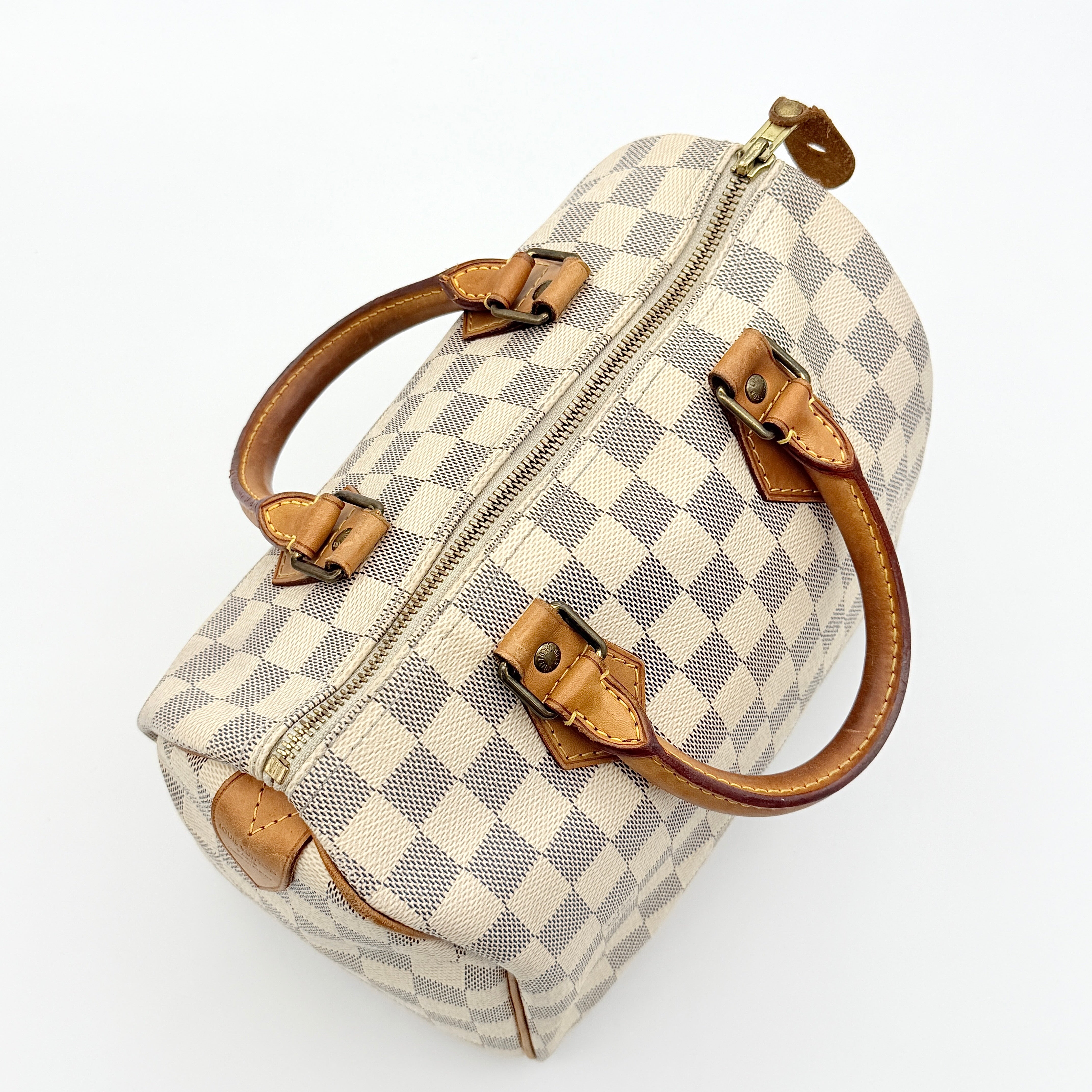 Louis Vuitton Damier Azur Speedy 25 handbag with natural leather handles, brass hardware, and included LV padlock and keys.