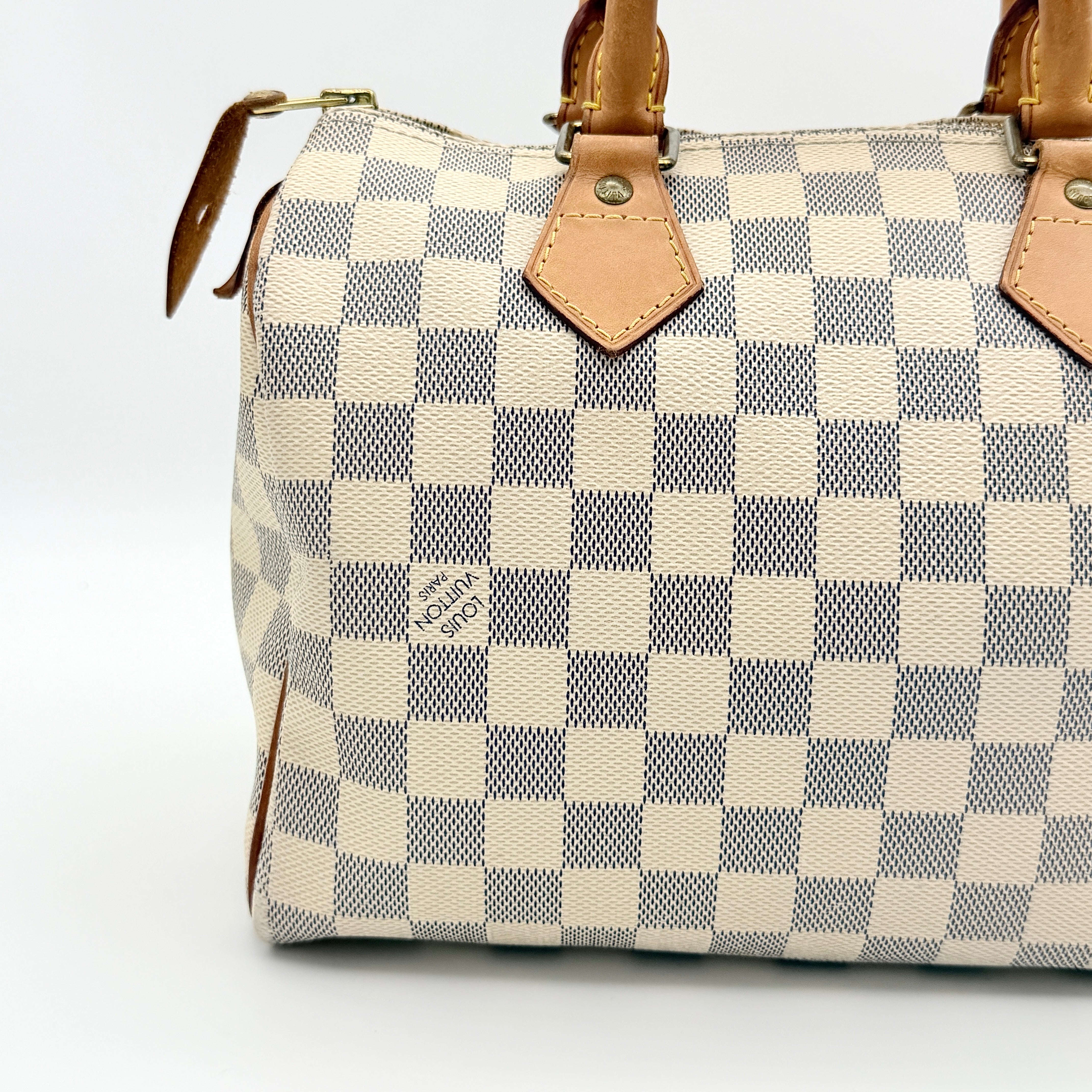 Louis Vuitton Damier Azur Speedy 25 handbag with natural leather handles, brass hardware, and included LV padlock and keys.