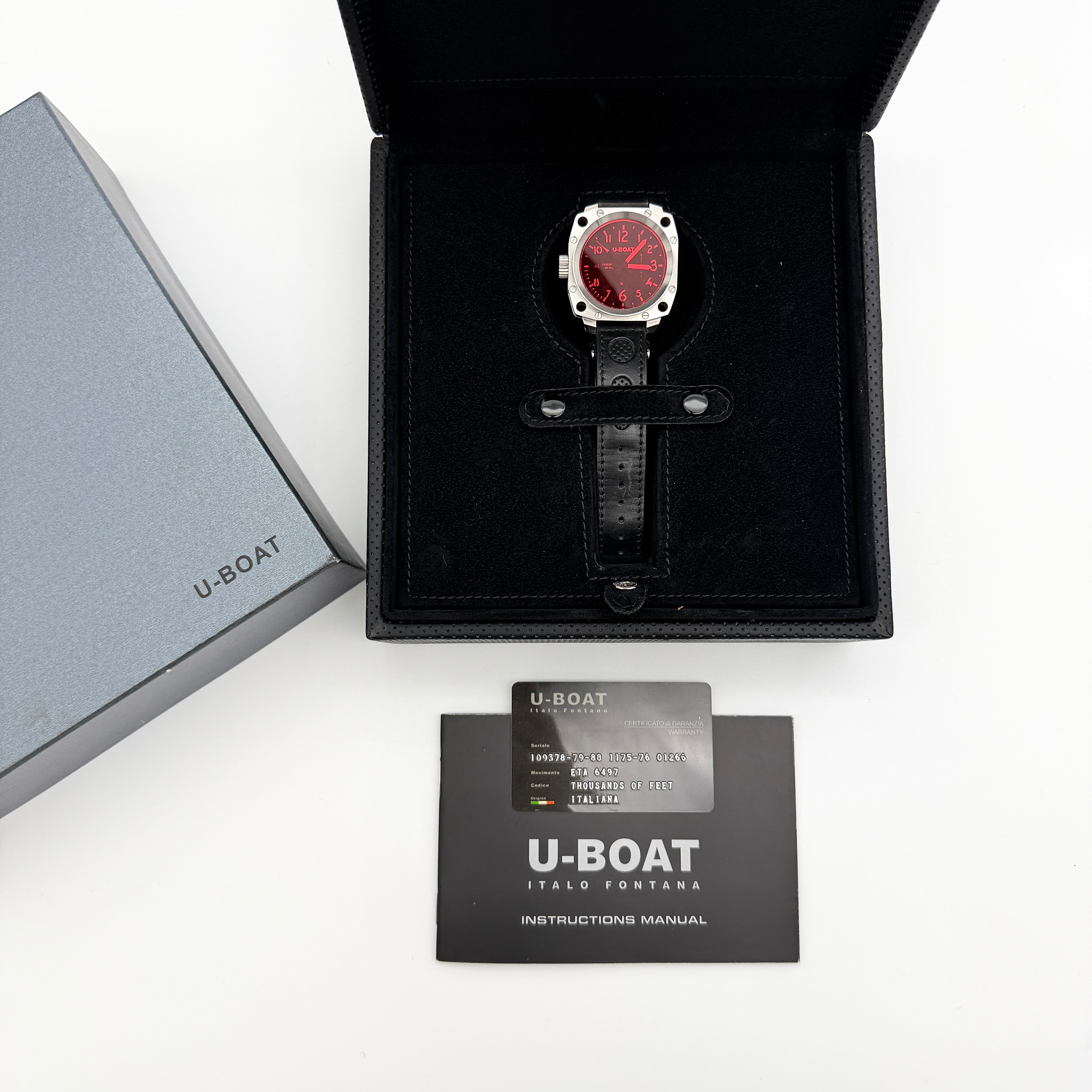 U-Boat Thousands Of Feet stainless steel watch with red dial and black leather strap, displayed on black branded box