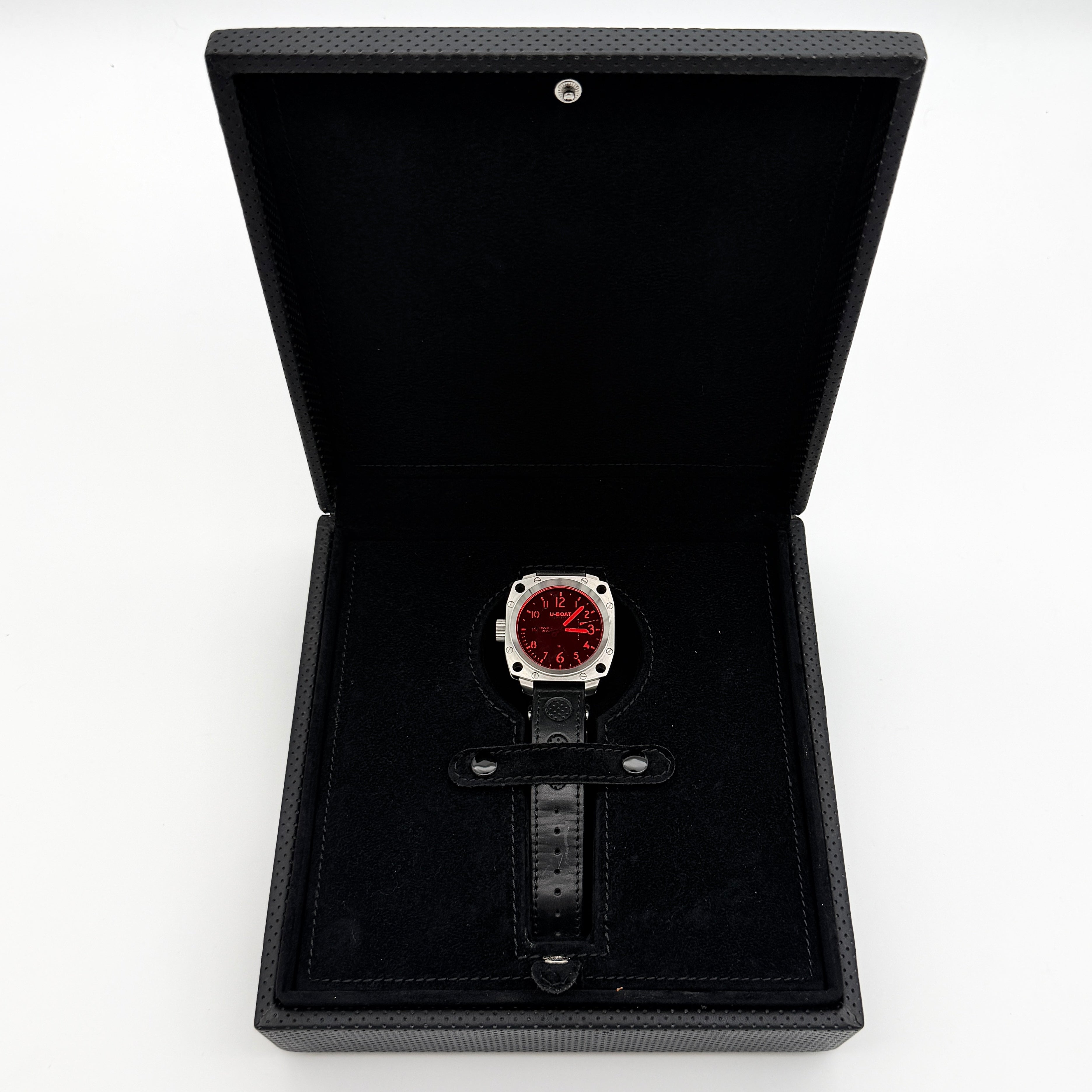 U-Boat Thousands Of Feet stainless steel watch with red dial and black leather strap, displayed on black branded box