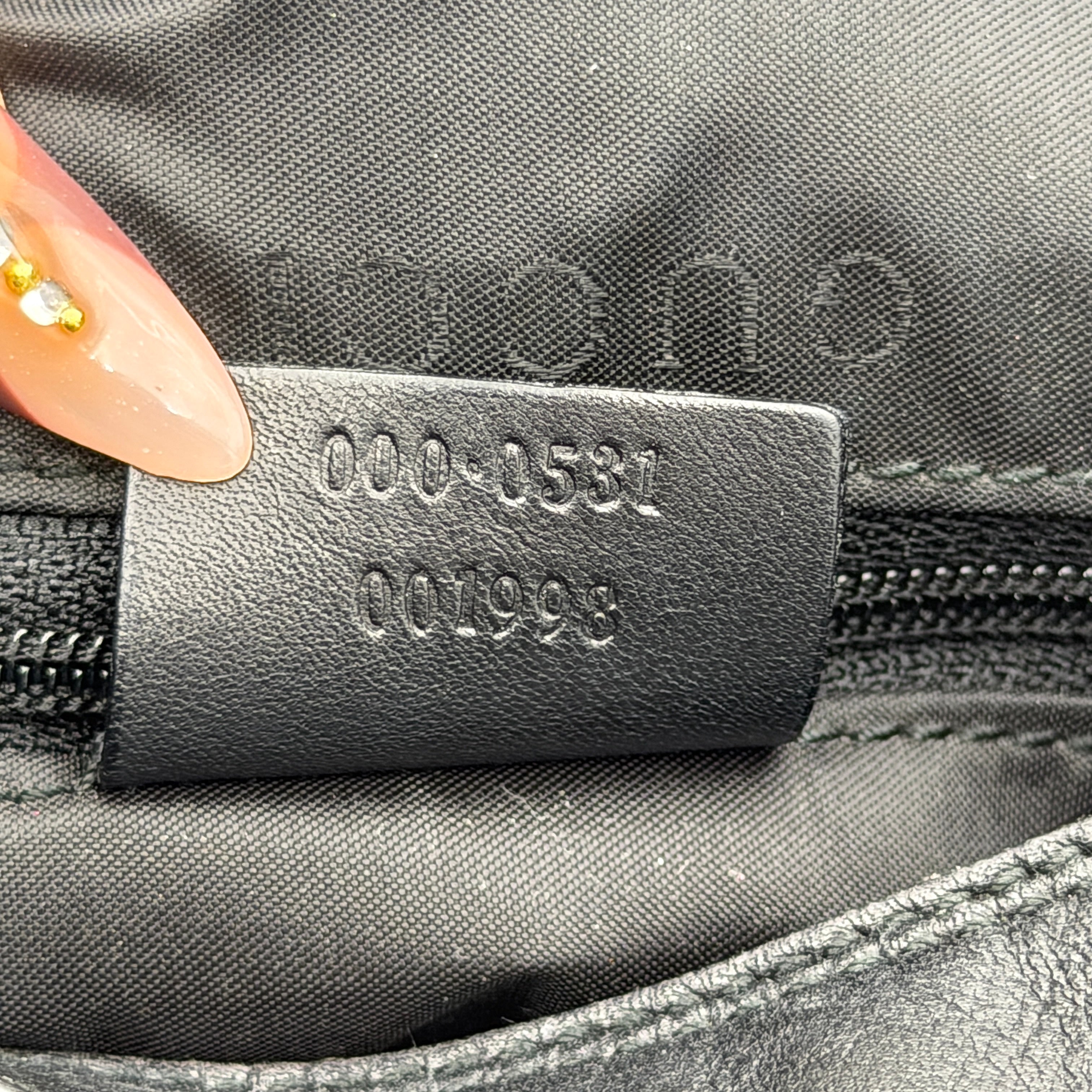 Gucci black leather hobo bag with bamboo handle and silver-tone hardware shown against a white background.