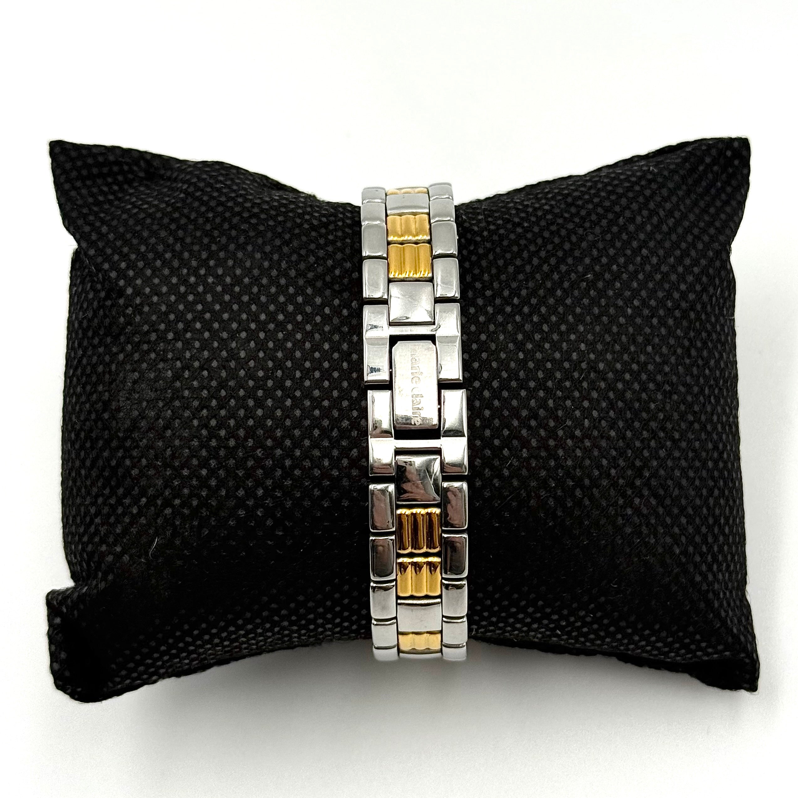 Marie Claire Paris 085268-00 two-tone gold and silver watch with a champagne dial, shown on a black pillow.