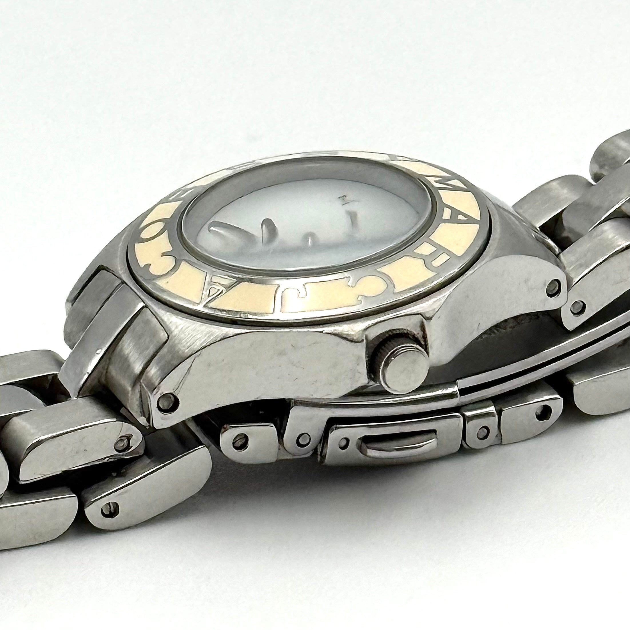 Marc Jacobs Blade MBM3049 watch in stainless steel with a cream bezel, shown on a black cushion.