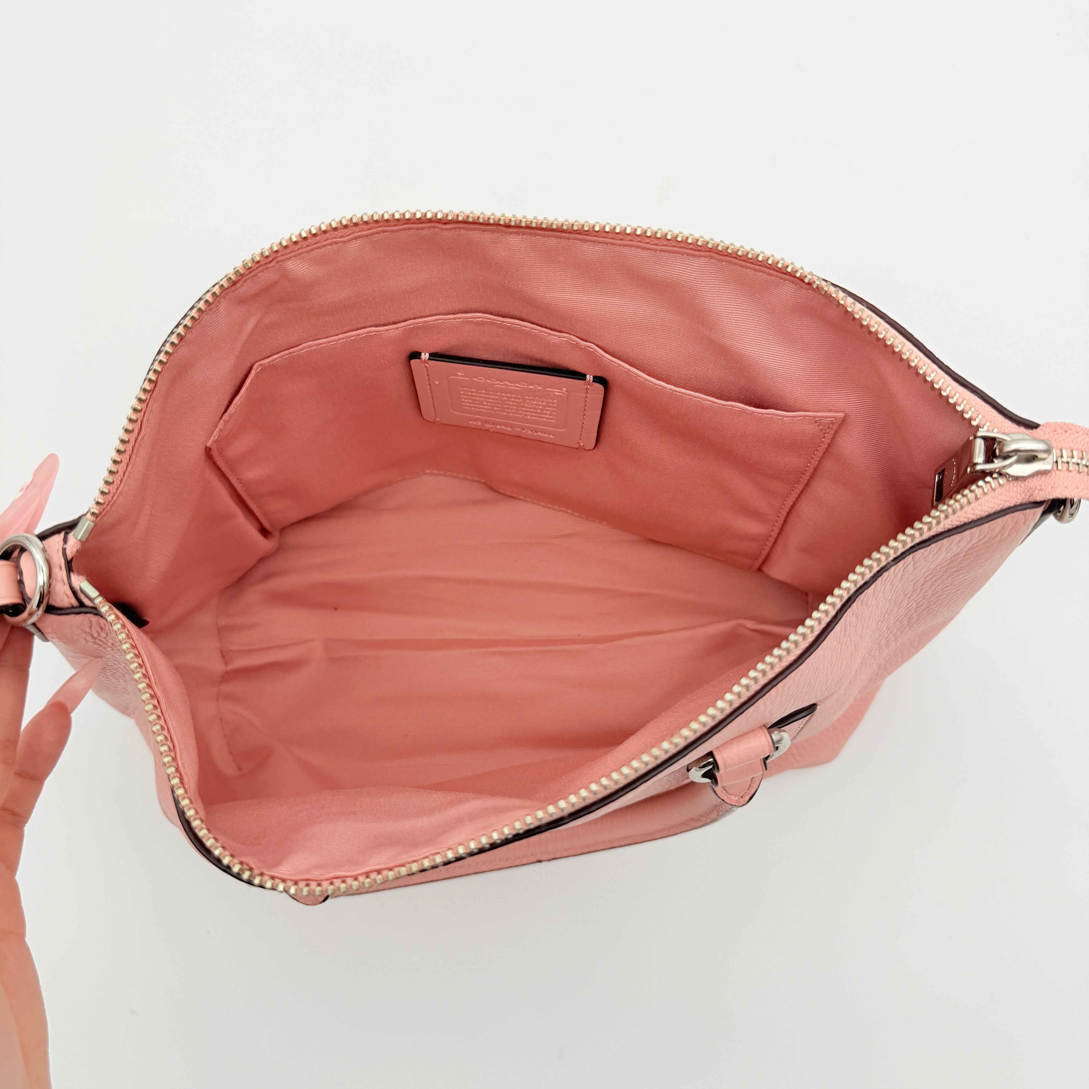 Coach Mini Emma Satchel in pink pebbled leather with silver-tone hardware, shown with detachable strap.