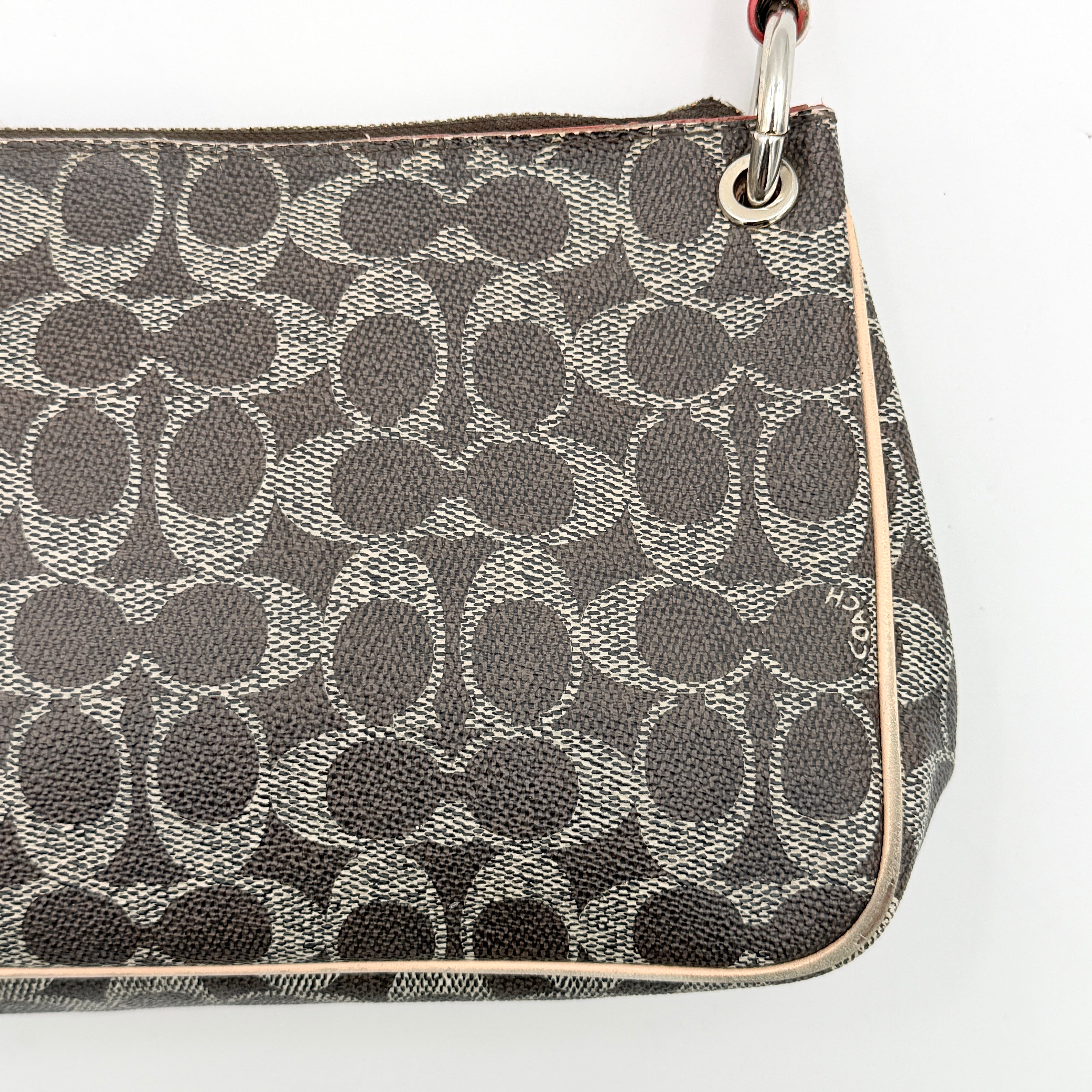 Coach Signature Charley Shoulder Bag in grey and beige canvas with monogram print, tan leather trim, and a single leather strap.