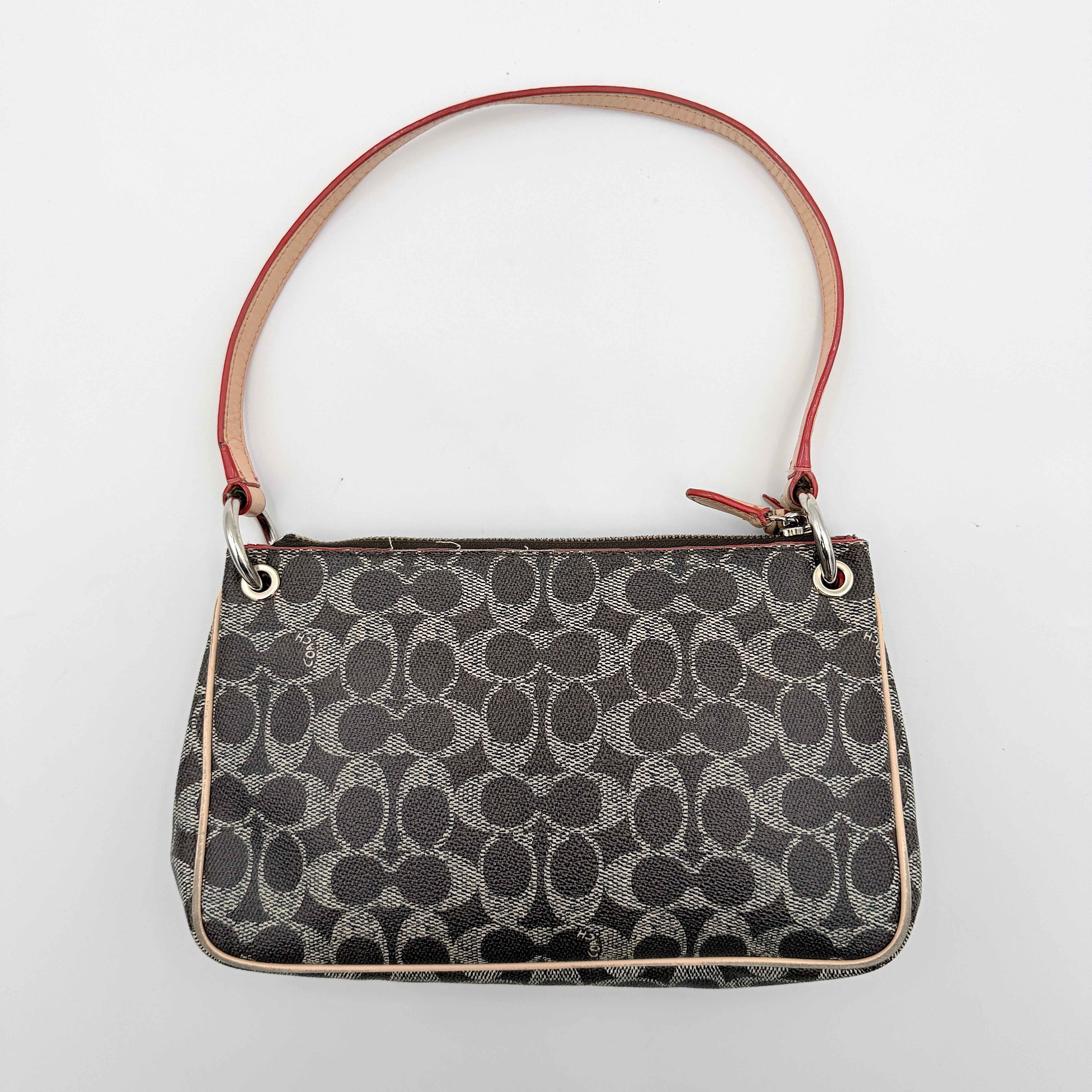Coach Signature Charley Shoulder Bag in grey and beige canvas with monogram print, tan leather trim, and a single leather strap.