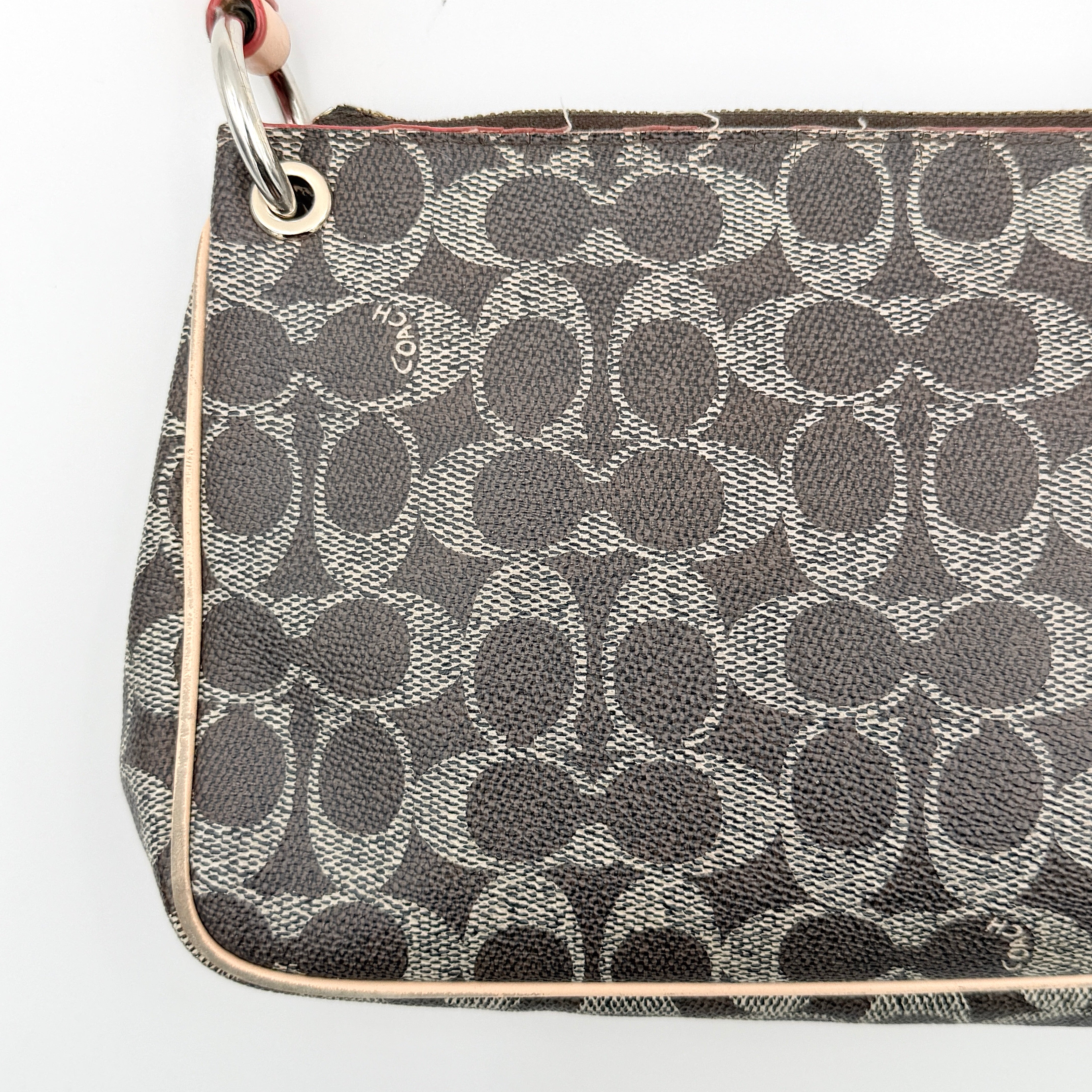 Coach Signature Charley Shoulder Bag in grey and beige canvas with monogram print, tan leather trim, and a single leather strap.