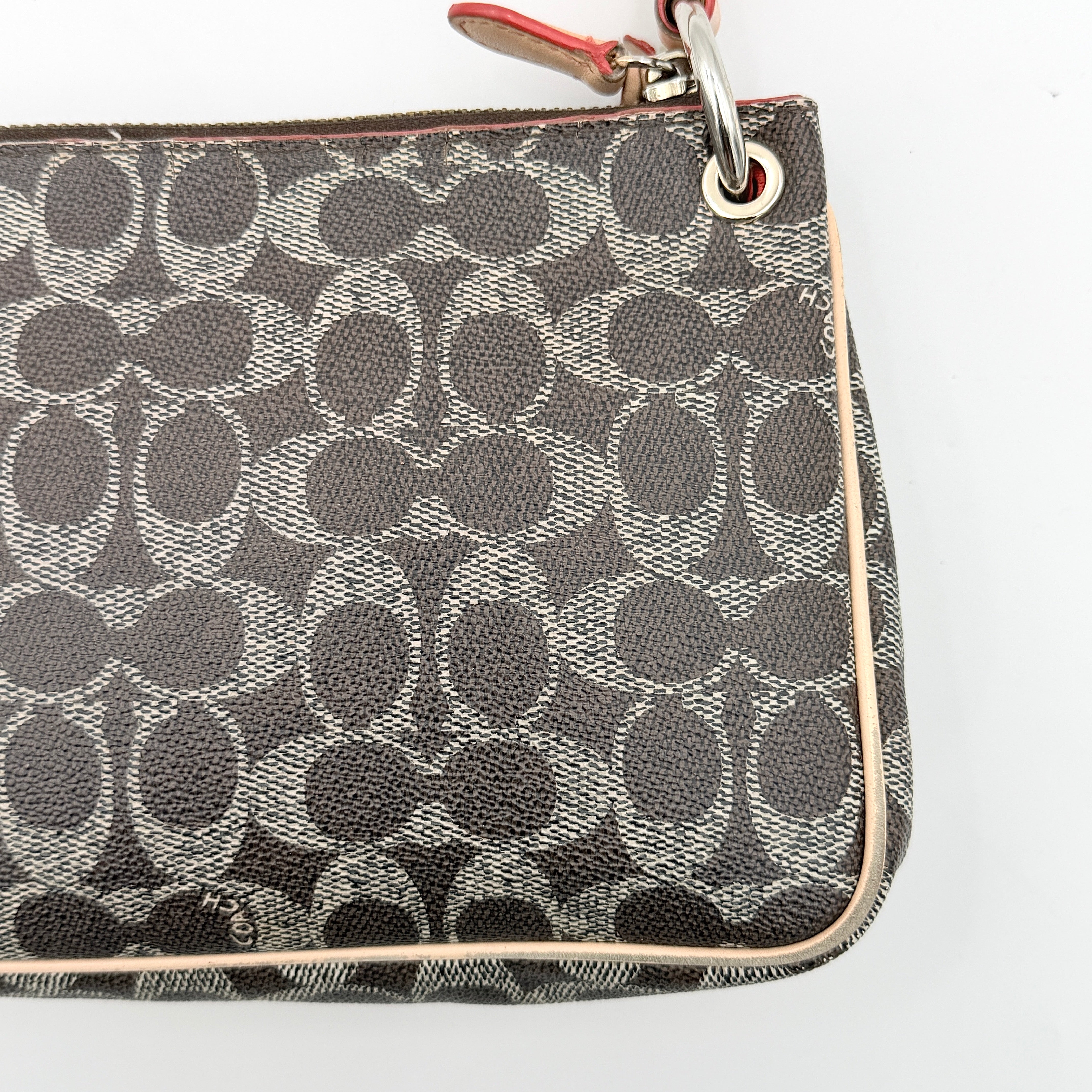 Coach Signature Charley Shoulder Bag in grey and beige canvas with monogram print, tan leather trim, and a single leather strap.