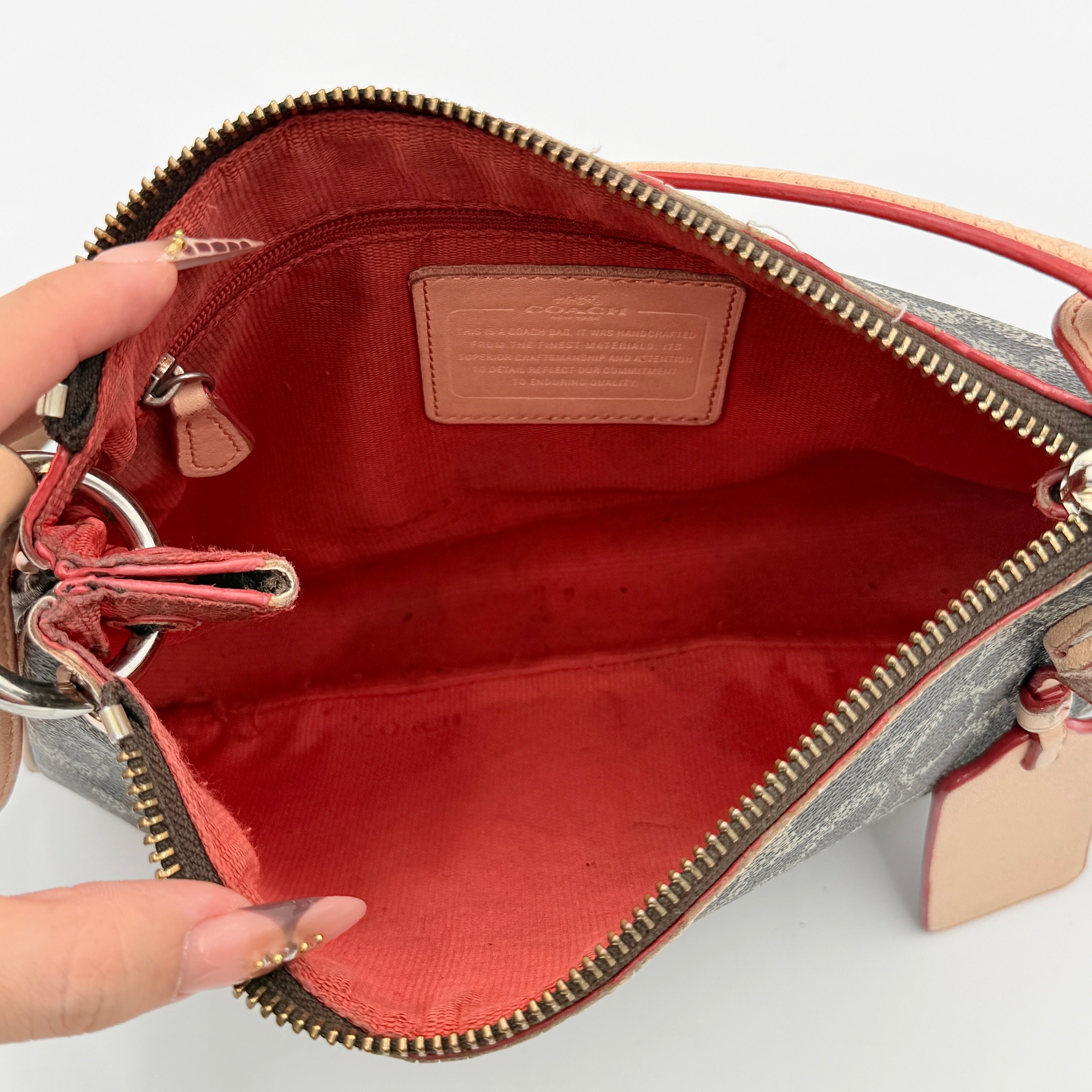Coach Signature Charley Shoulder Bag in grey and beige canvas with monogram print, tan leather trim, and a single leather strap.